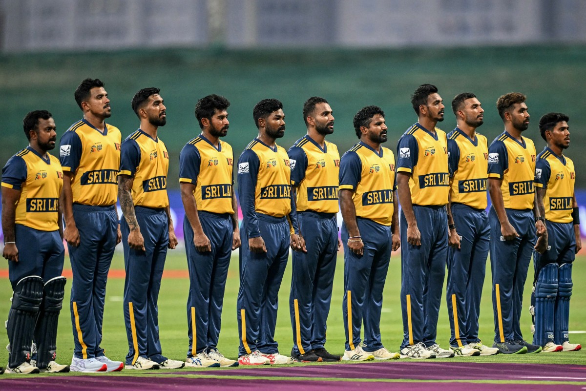 Sri Lanka's players stand for their national anthem before the start of the Asia Cup 2025 Super Four Twenty20 international cricket match between Pakistan and Sri Lanka at the Sheikh Zayed Cricket Stadium in Abu Dhabi on September 23, 2025. (Photo by Sajjad HUSSAIN / AFP)