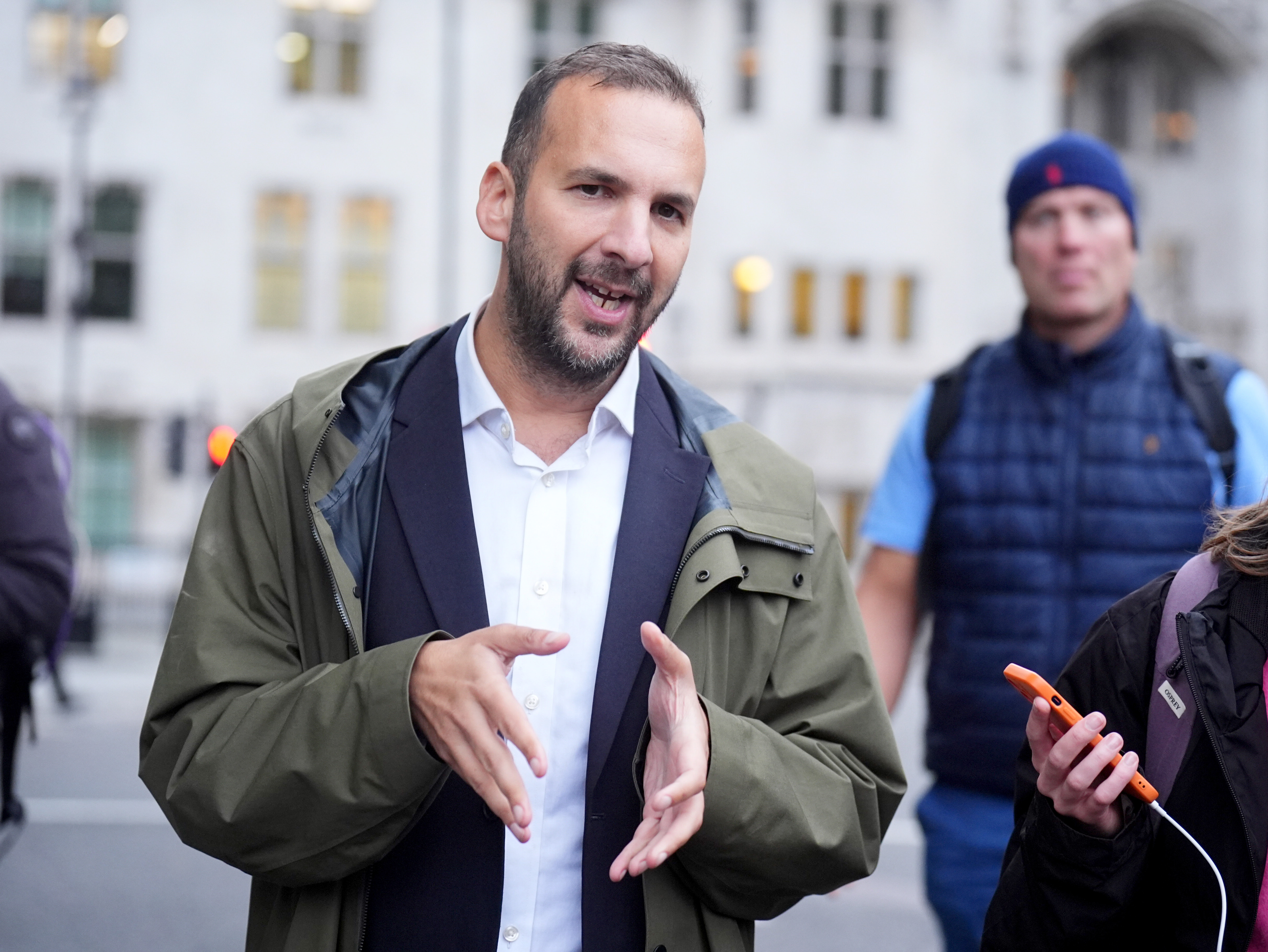 Leader of the UK's Green Party, Zack Polanski, speaks to the media during a Stop Trump Coalition protest in Parliament Square, London