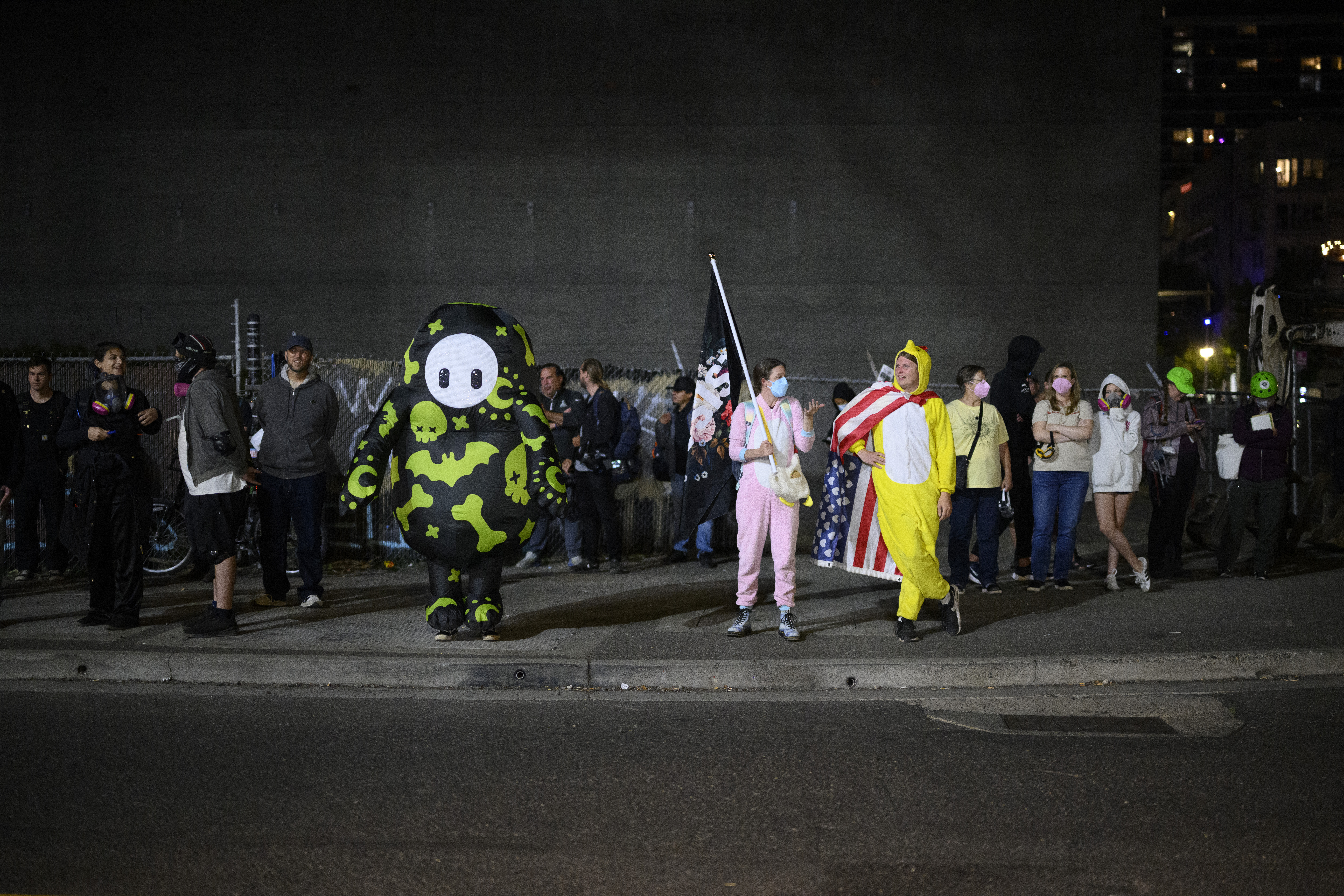 PORTLAND, OREGON - SEPTEMBER 27: Protesters stand outside the U.S. Immigration and Customs Enforcement building on September 27, 2025 in Portland, Oregon. In a Truth Social post, President Trump authorized the deployment of military troops to "protect War ravaged Portland, and any of our ICE Facilities under siege from attack by Antifa, and other domestic terrorists." Mathieu Lewis-Rolland/Getty Images/AFP (Photo by Mathieu Lewis-Rolland / GETTY IMAGES NORTH AMERICA / Getty Images via AFP)
