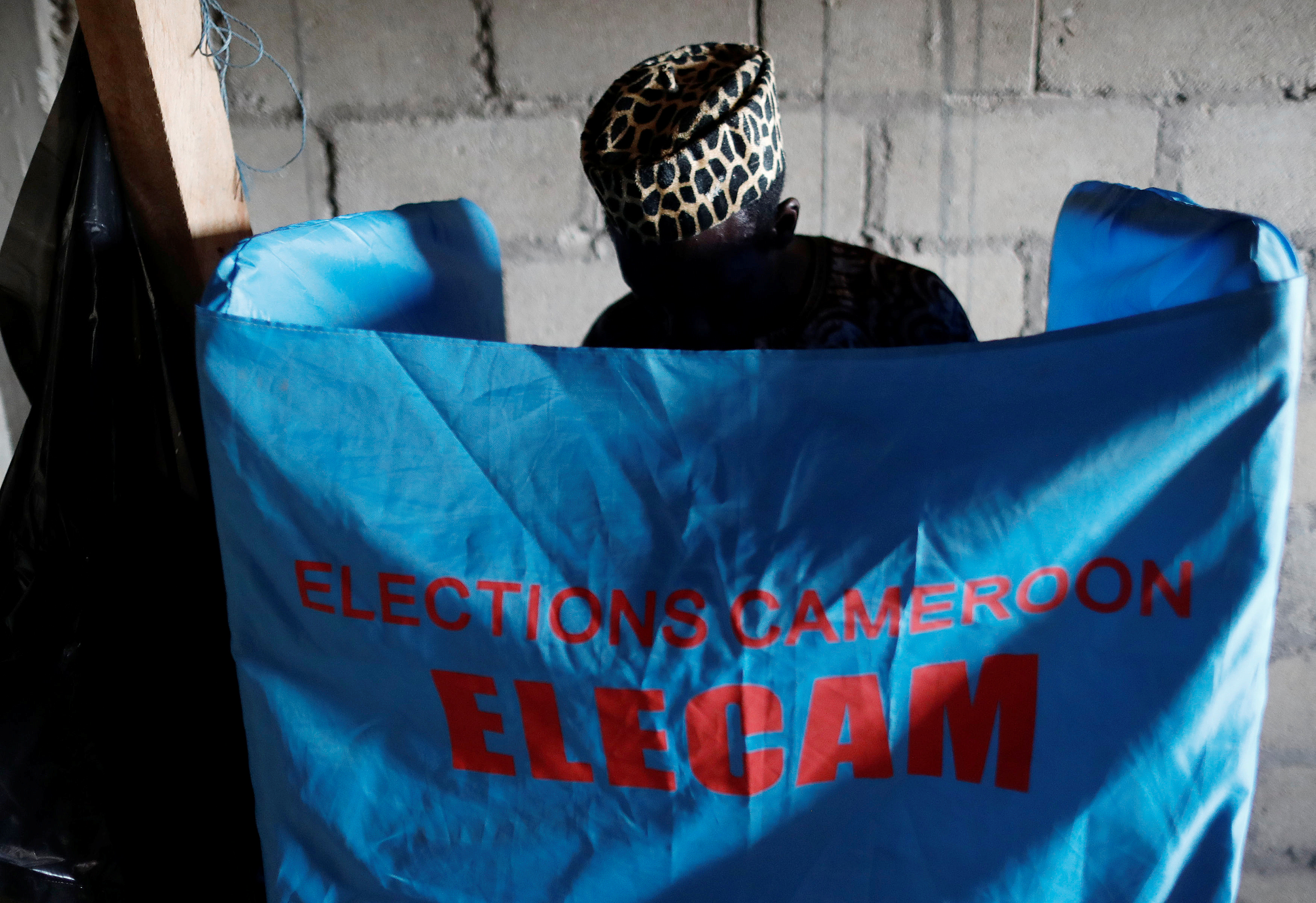 A man casts his ballot at a polling station during the presidential election in Yaounde, Cameroon in 2018