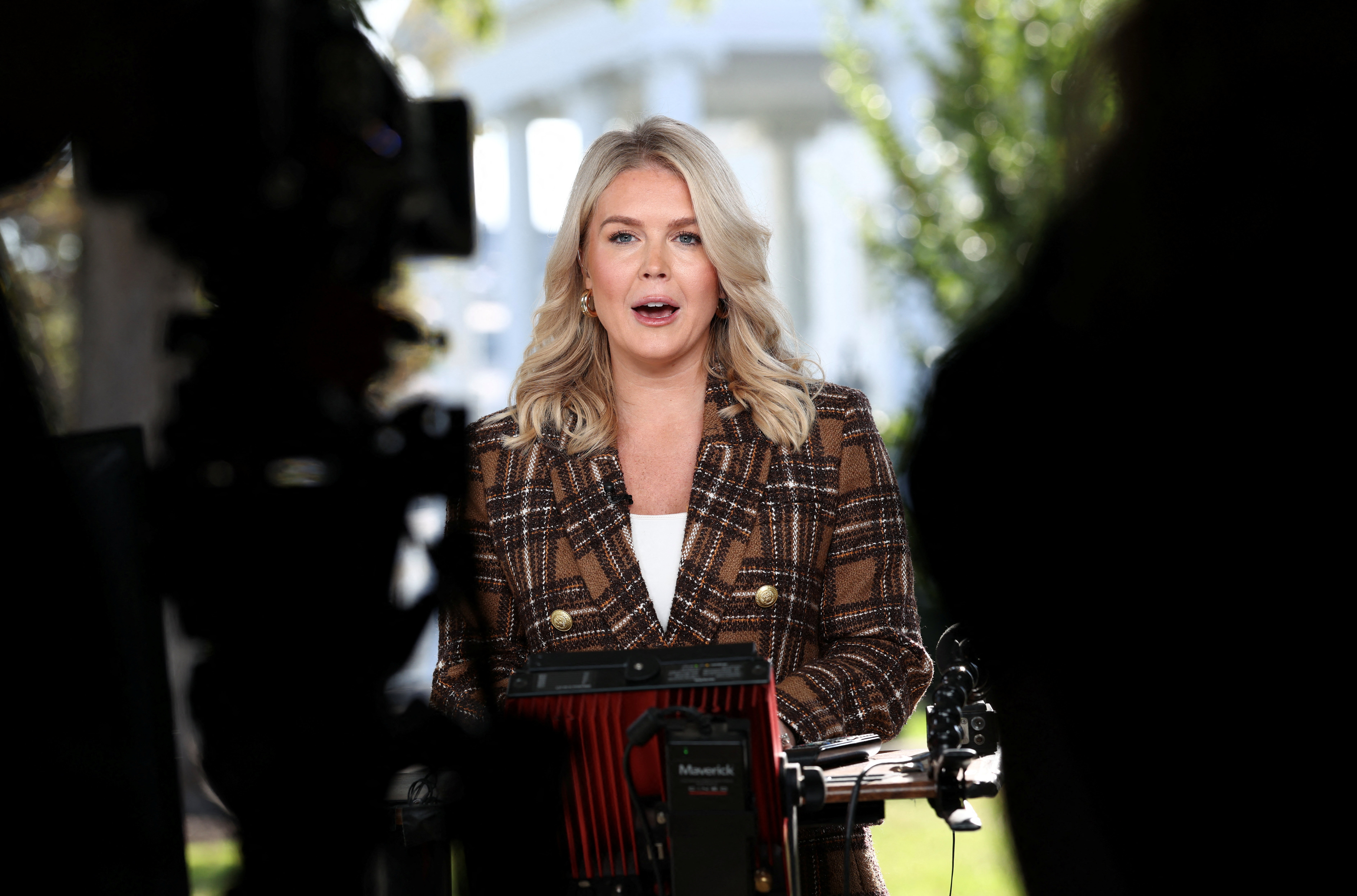 Karoline Leavitt speaks to reporters outside the White House.