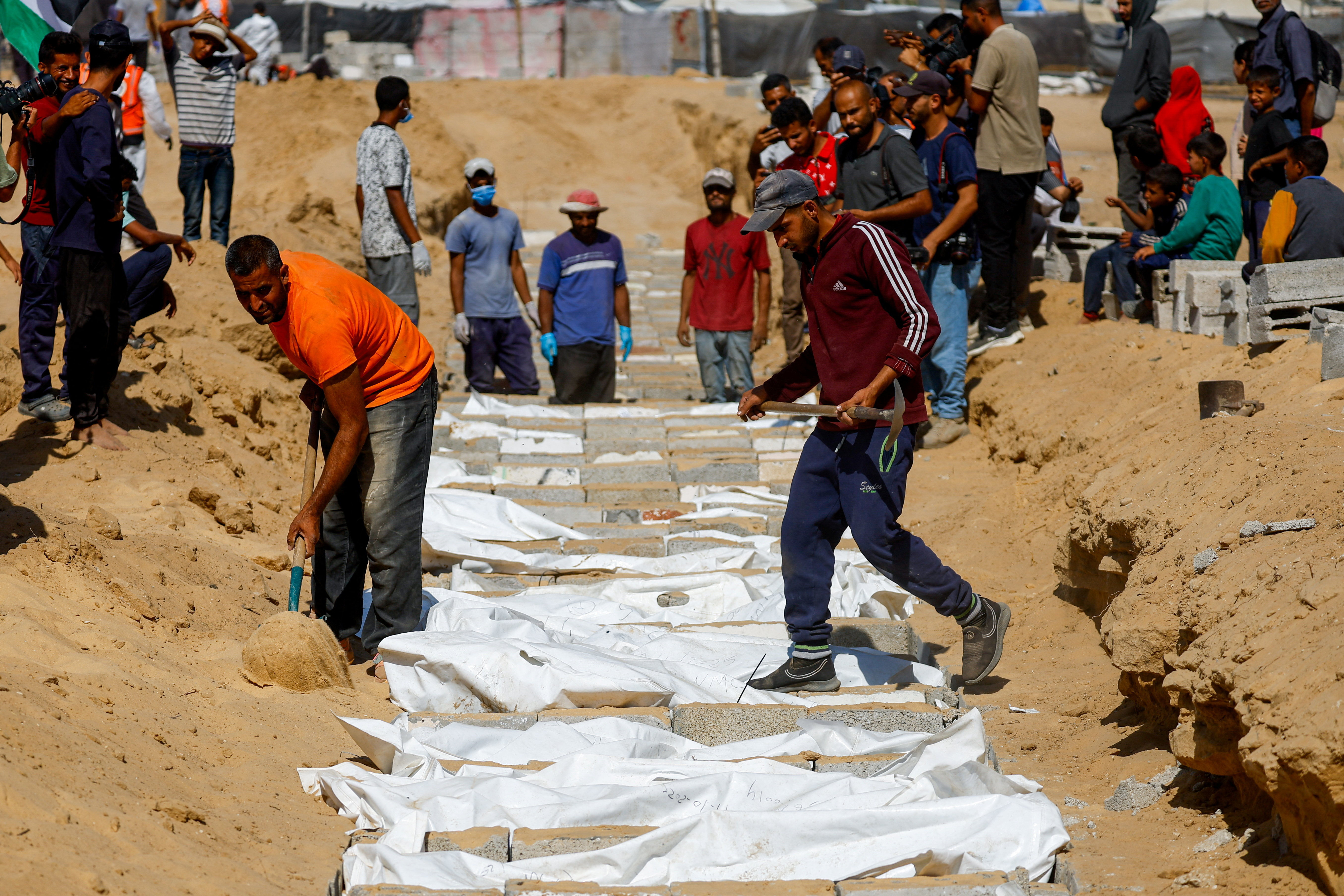 Families mourn as mass burial held for unidentified Palestinians in Gaza