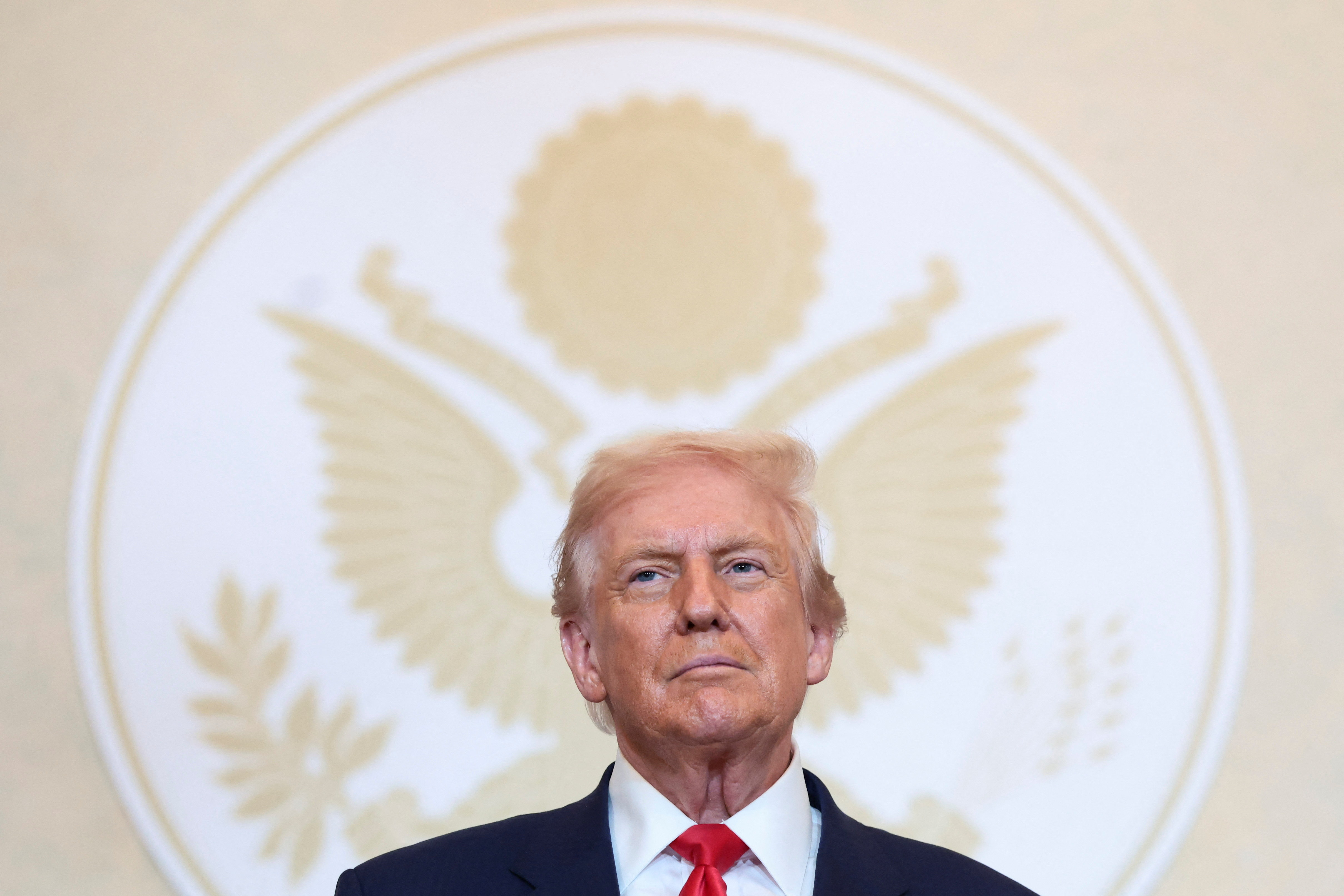 Trump in front of a presidential seal