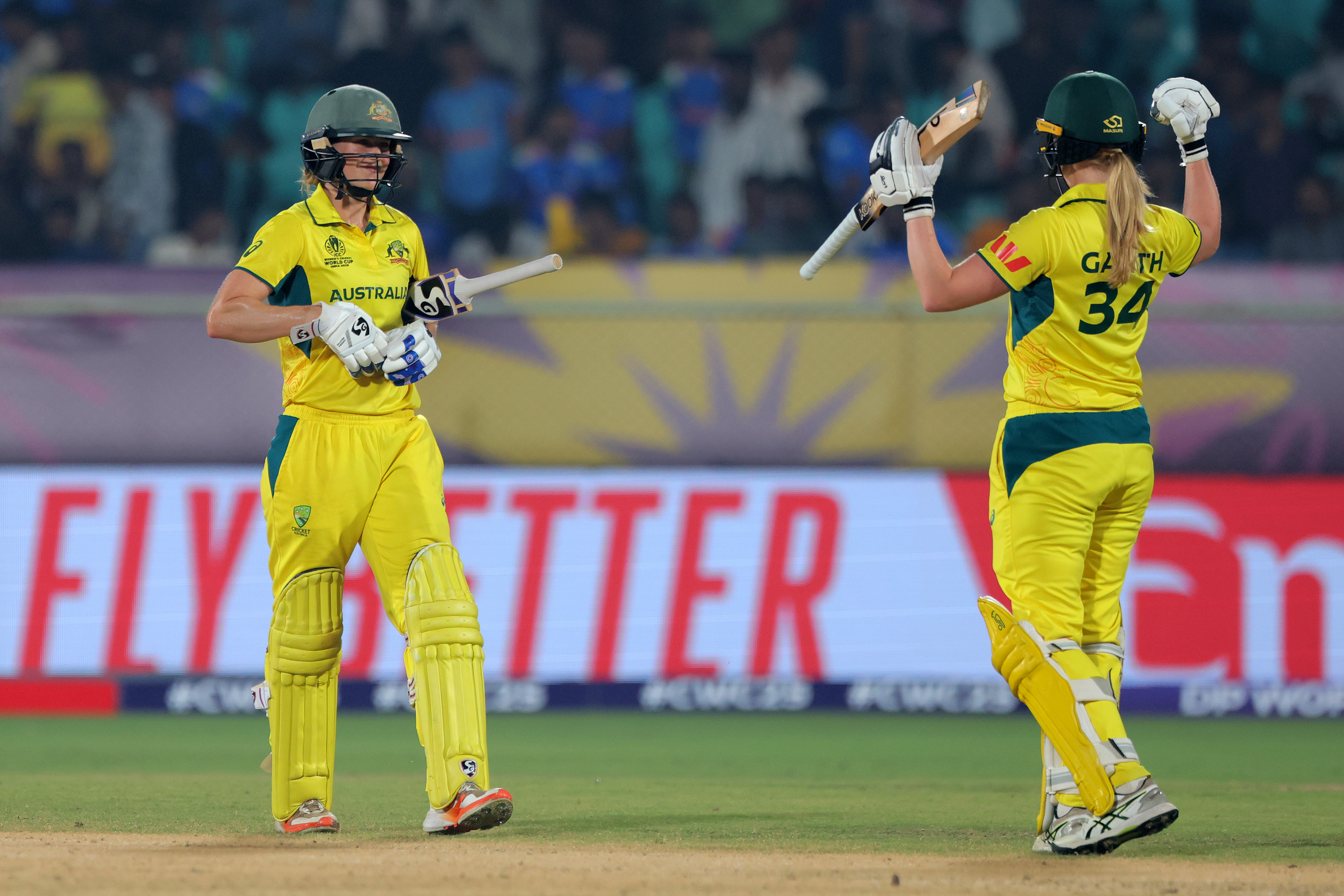 VISAKHAPATNAM, INDIA - OCTOBER 12: Ellyse Perry (L) of Australia celebrates with team mate Kim Garth (R) after hitting out for six to complete the record breaking run chase of 331 and win the ICC Women's Cricket World Cup India 2025 match between India and Australia at Dr. Y.S. Rajasekhara Reddy ACA-VDCA Cricket Stadium on October 12, 2025 in Visakhapatnam, India. (Photo by Pankaj Nangia/Getty Images)