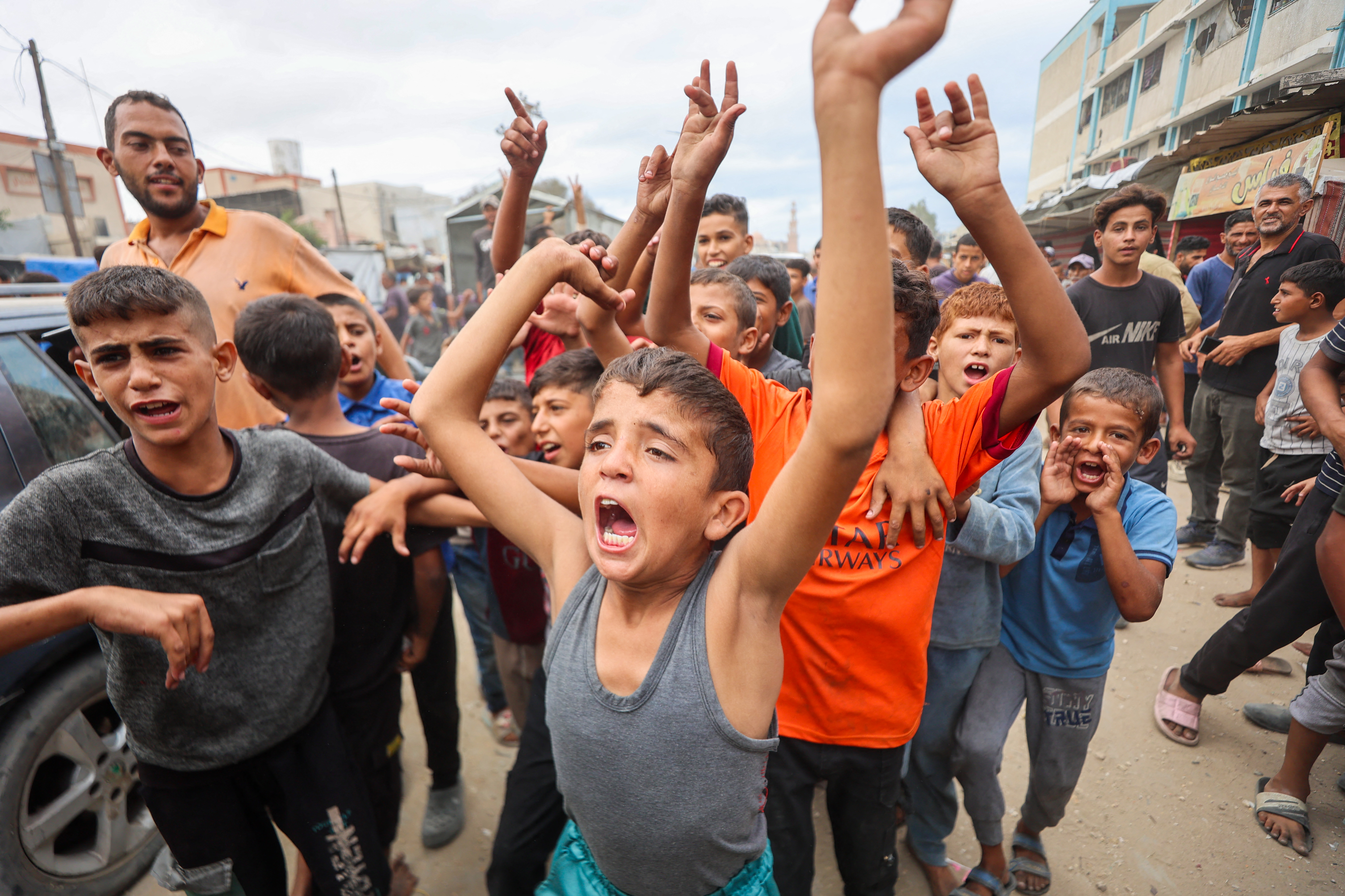 Palestinian children celebrate in Khan Yunis on October 9, 2025, following news of a new Gaza ceasefire deal.