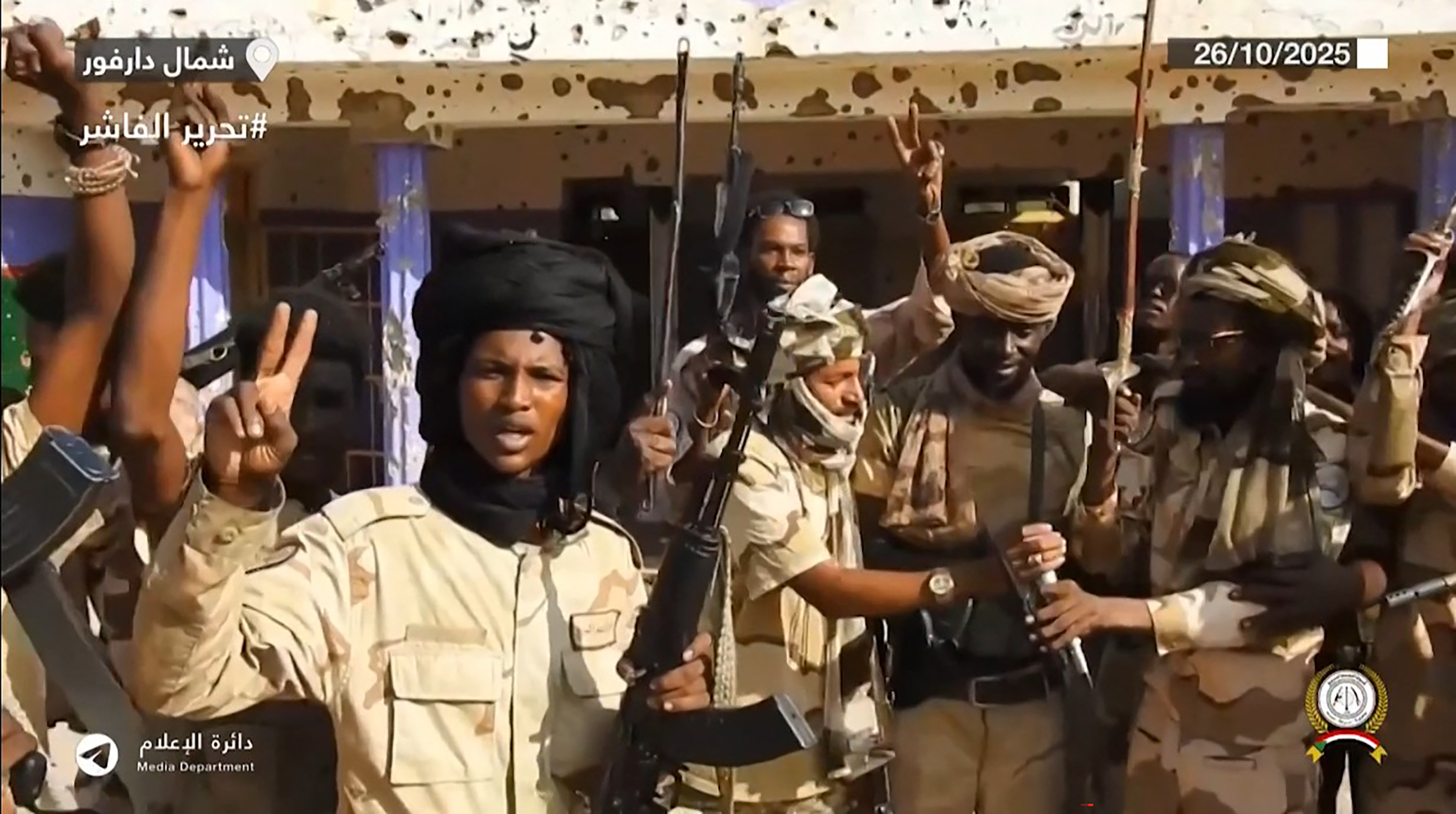 This image grab taken from handout video footage released on Sudan's paramilitary Rapid Support Forces (RSF) Telegram account on October 26, 2025, shows RSF fighters holding weapons and celebrating in the streets of El-Fasher in Sudan's Darfur.