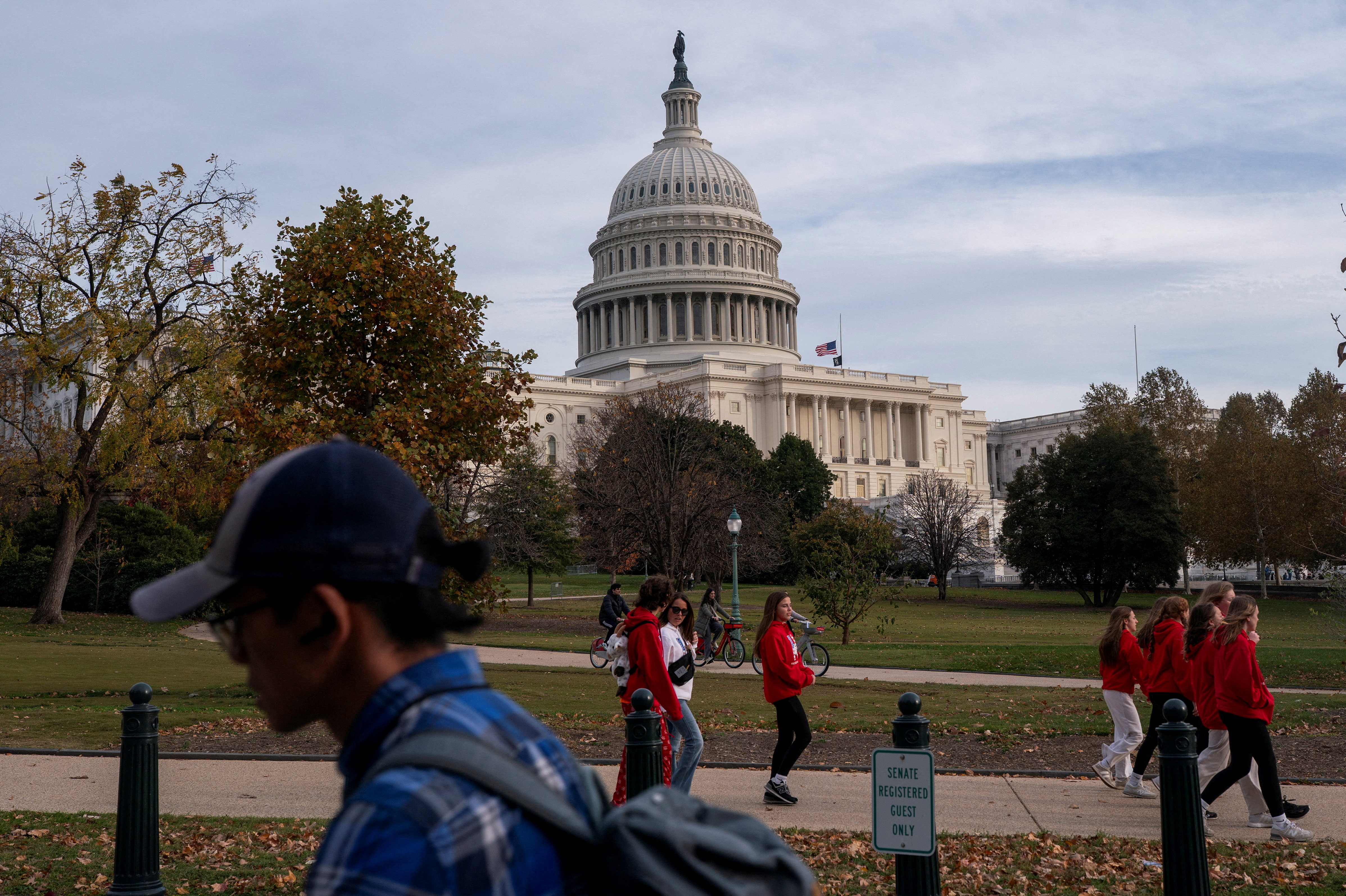 Tourists walk past the U.S. Capitol more than a month into the continuing U.S. government shutdown in Washington, D.C., U.S., November 7, 2025.