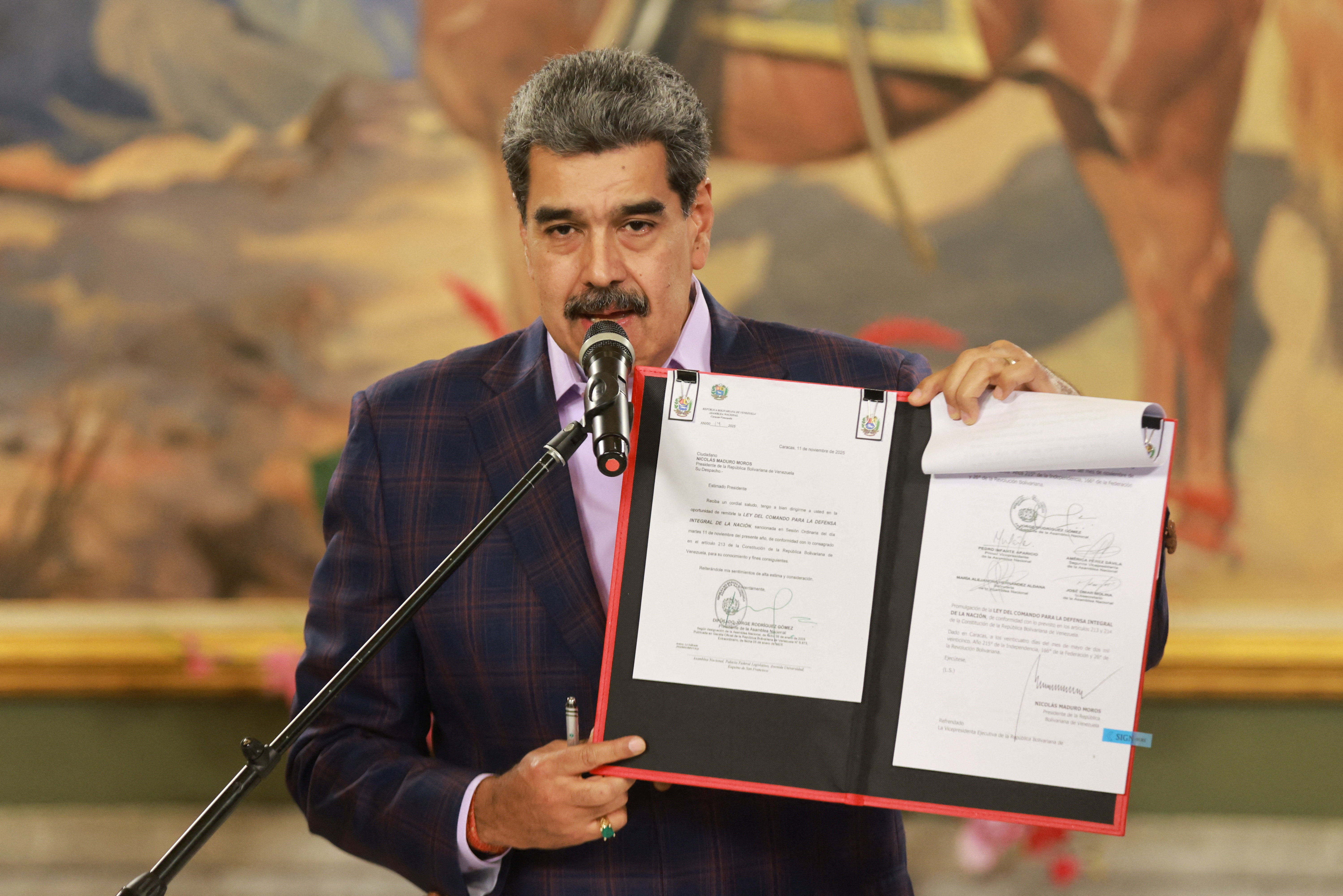 Venezuelan President Nicolas Maduro holds a national defence framework approved by the National Assembly ordering the immediate activation of “integral defence commands” to unify civilian and military forces