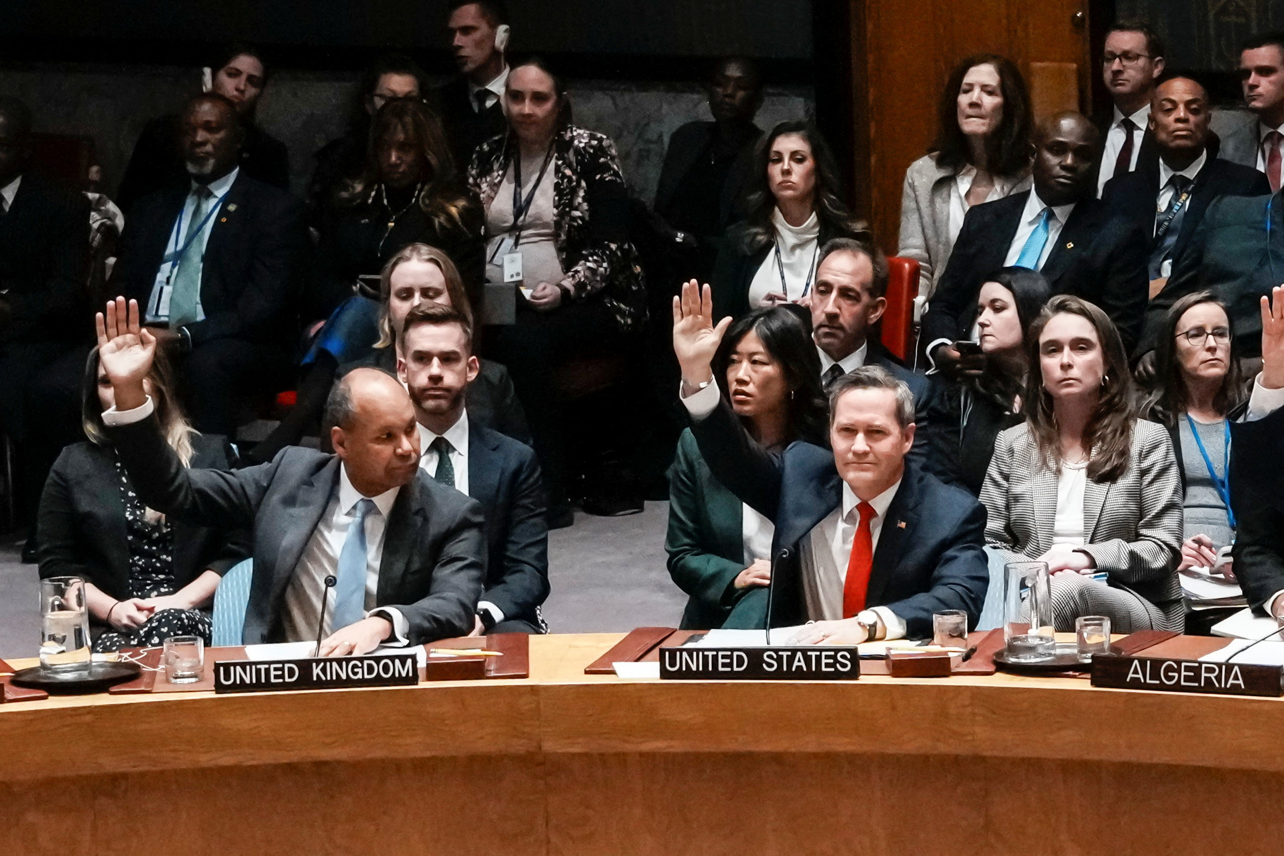 US ambassador to United Nations Michael Waltz and Britain's Deputy Ambassador to the United Nations James Kariuki vote during a meeting of the UN Security Council to consider a in New York City, US, November 17, 2025. [Eduardo Munoz/Reuters]