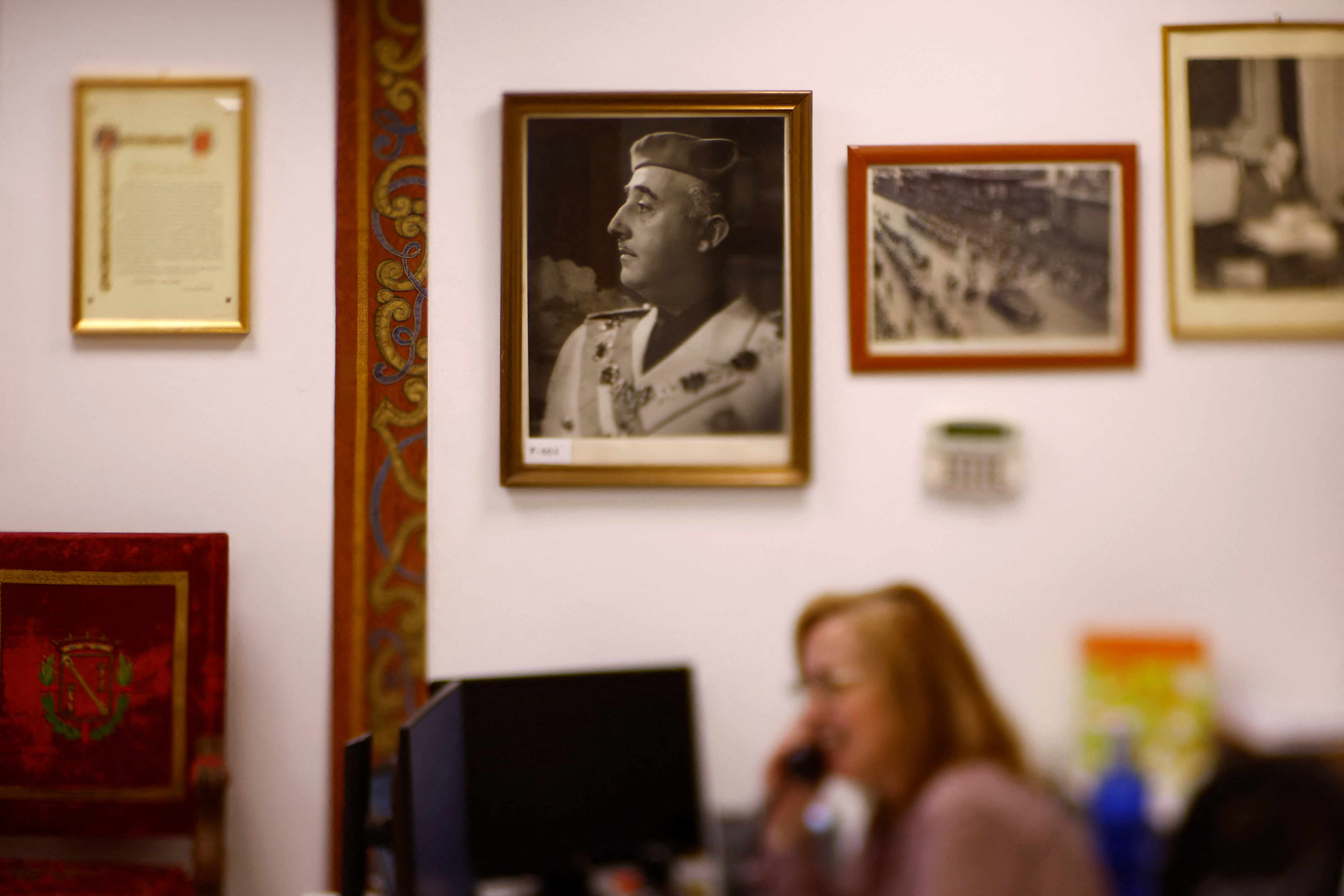A photograph of Spain's former dicator Francisco Franco hangs next to other Franco memorabilia at the Francisco Franco foundation in Madrid, Spain, April 7, 2025. Spain's government has begun closing down the Francisco Franco foundation, a non-profit organisation set up by sympathisers of the late dictator. The "Democratic Memory" law approved in 2022 by Spain's Socialist government prohibits organisations that glorify or promote the 1939-1975 Franco regime. The foundation was created in 1976 to promote the study of Franco's life and achievements, according to its website. Spain transitioned to democracy after Franco's death in 1975, but the legacy of his dictatorship still divides society fifty years later. REUTERS/Susana Vera
