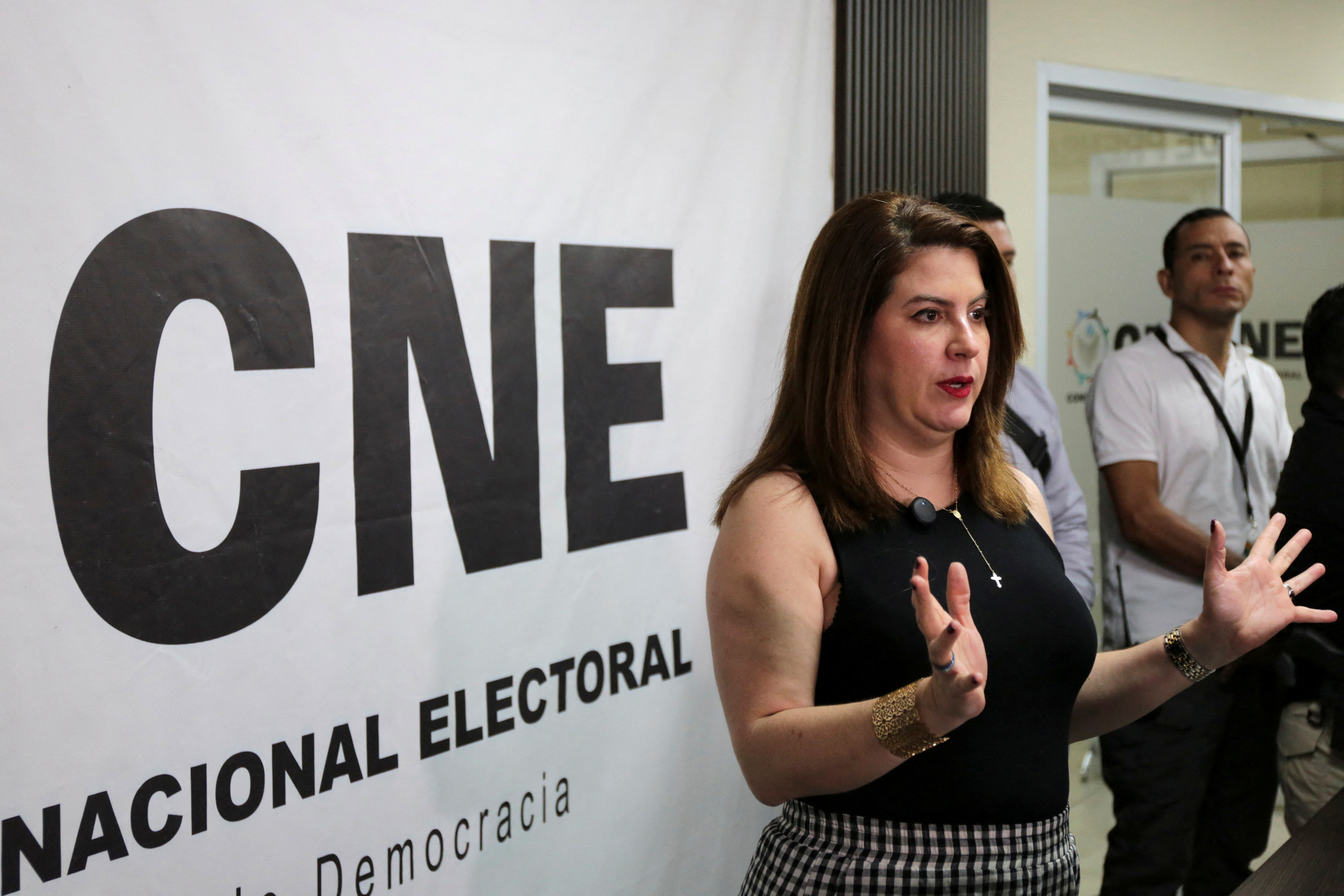 Cossette Lopez speaks in front of a CNE banner