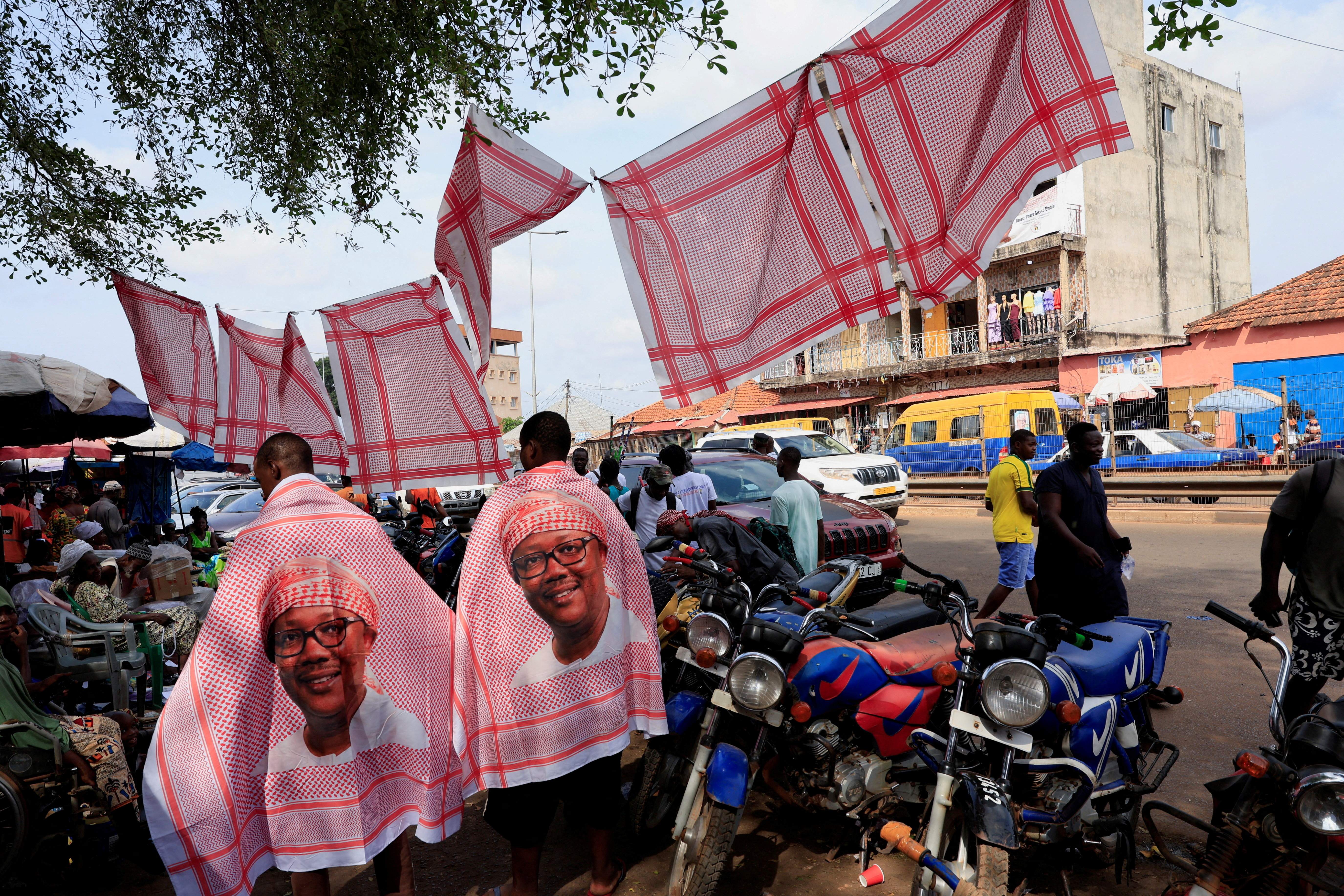 Supporters wear clothes featuring images of Guinea-Bissau’s incumbent President Umaro Sissoco Embalo, ahead of the presidential election scheduled for November 23, in Bissau, Guinea-Bissau, on November 21, 2025
