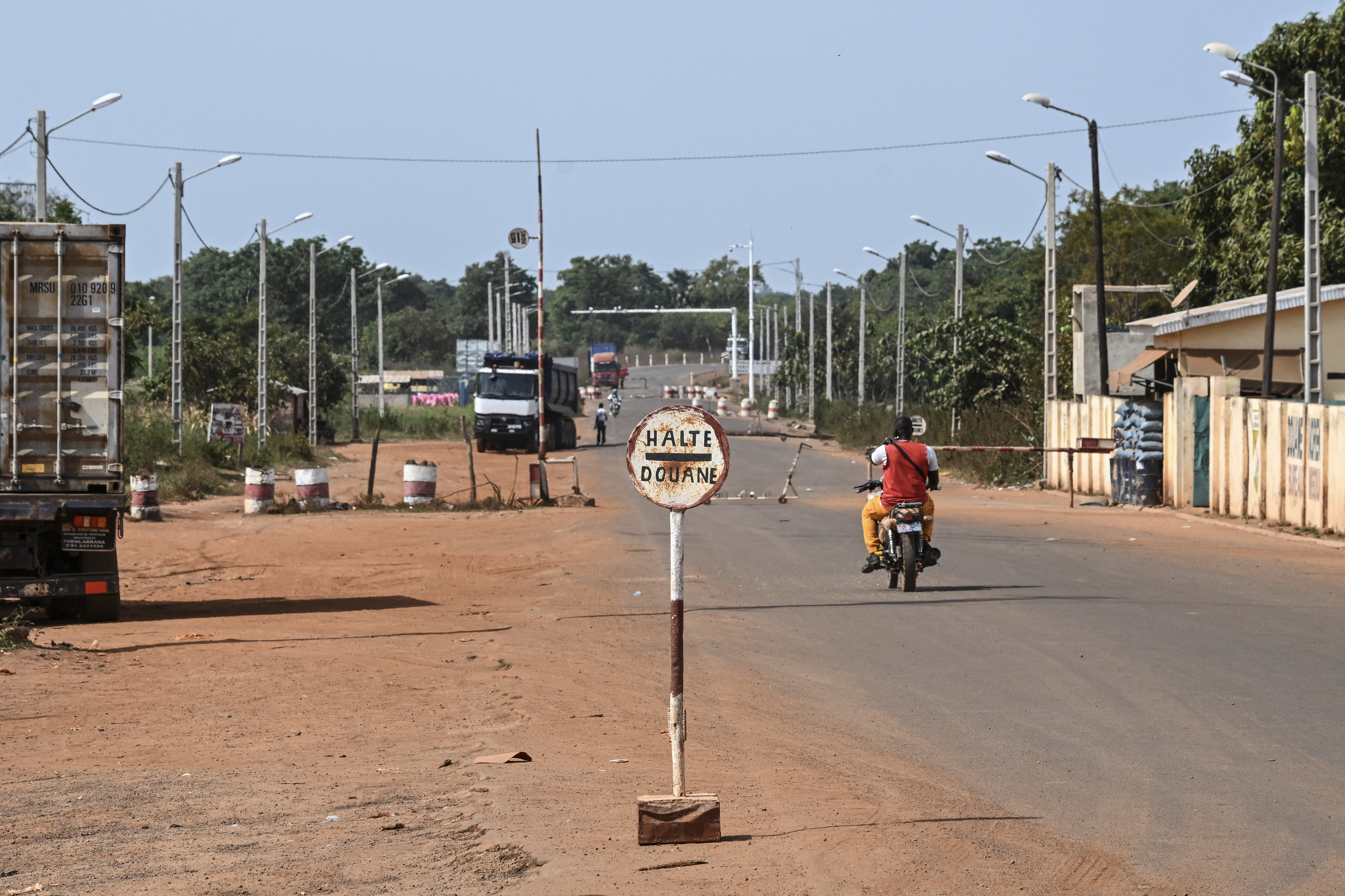 A general view of the border between Ivory Coast and Mali in village of Nigoun, near Tengrela, on October 31, 2025. In northern Ivory Coast, truck drivers prepare to head back to neighbouring Mali, aboard their tanker trucks loaded with fuel and anxiety. One acronym strikes fear into the hearts of all the truck drivers: JNIM, the name of the jihadist group affiliated with Al-Qaeda that decreed two months ago that no more tanker trucks would be allowed to enter Mali from a neighboring country.