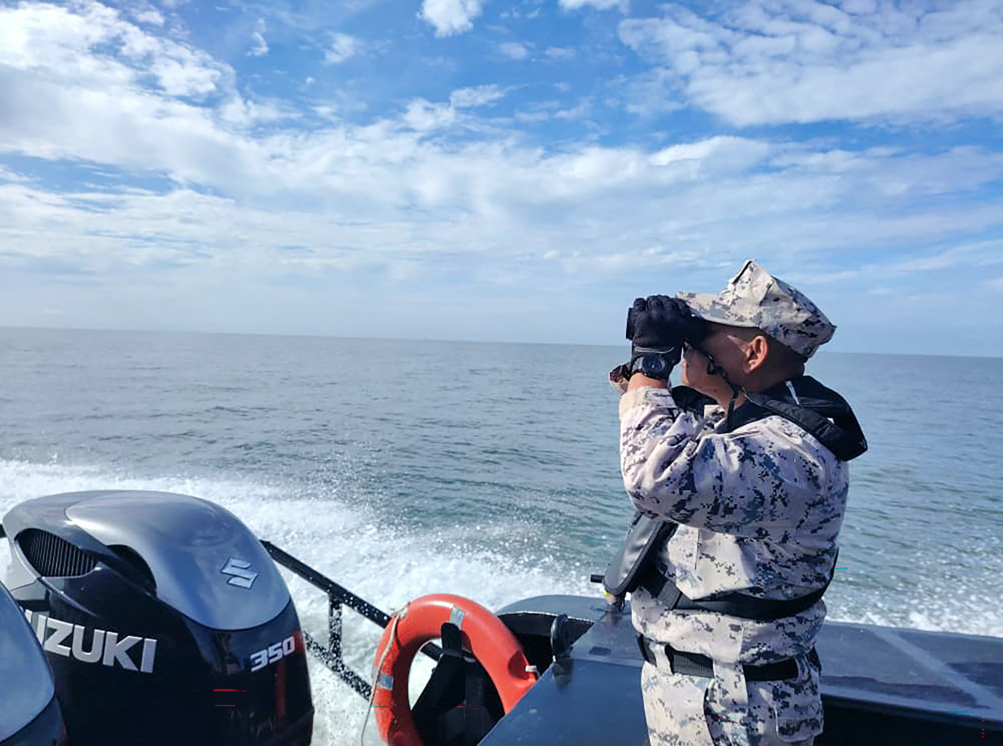 A staff member of the Malaysian Maritime Enforcement Agency (MMEA) searching for suvivors after a boat carrying migrants from Myanmar capsized near the MalaysiaThailand border, during a search and rescue operation off the coast of Langkawi.