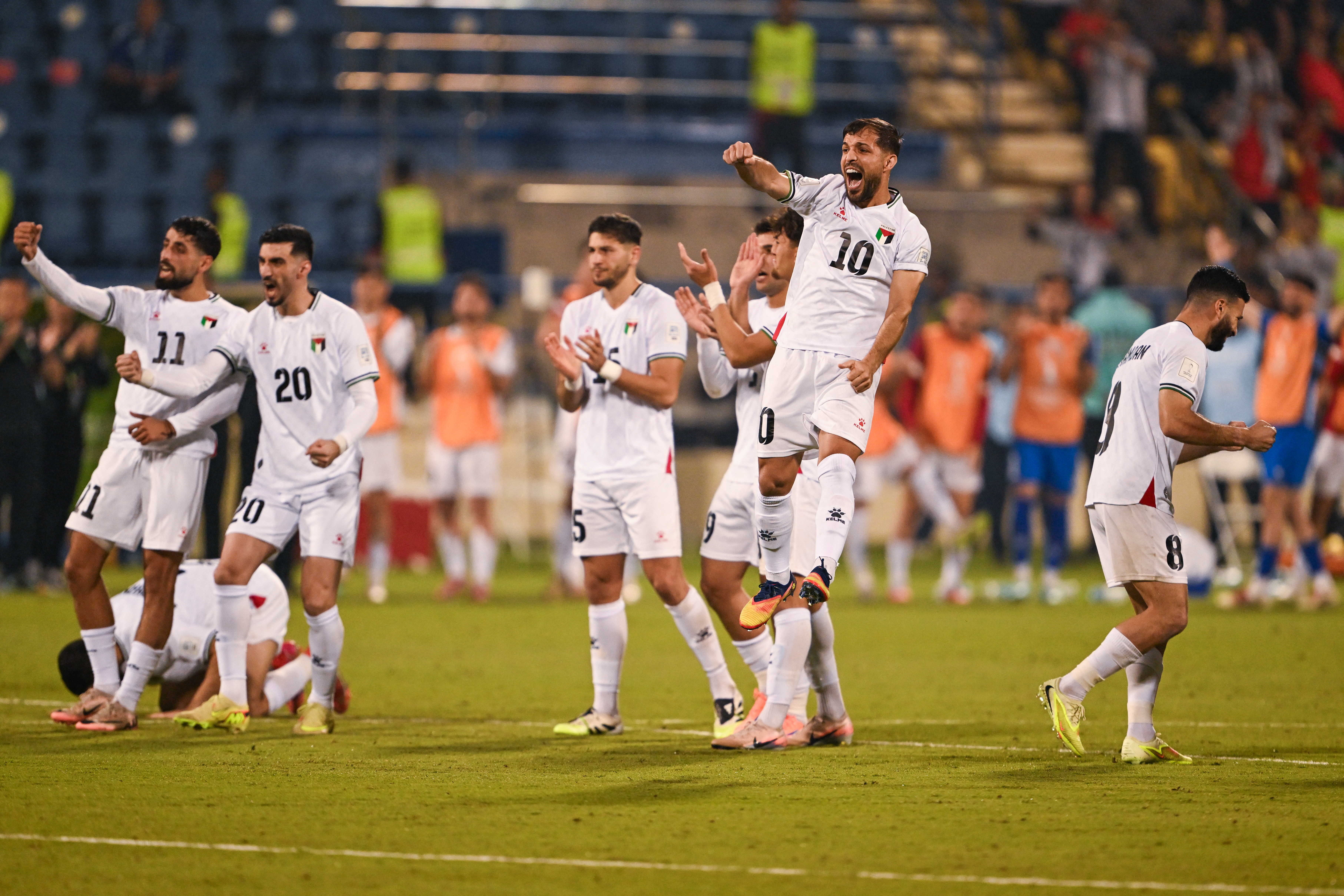 Palestine football players react.