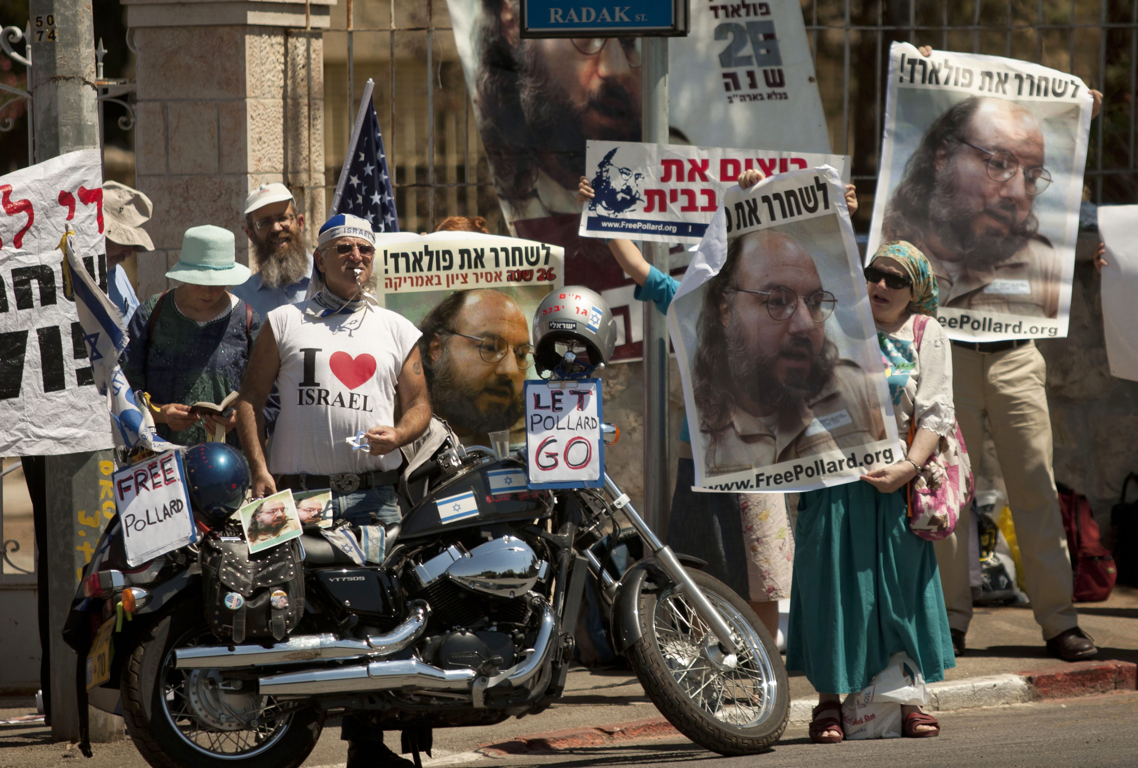 Israelis hold posters of Jonathan Pollard, who was convicted of spying for Israel during a protest calling for his release during a meeting Israel's President Shimon Peres and a delegation of 35 Republican congressmen, outside the president's residence in Jerusalem, Wednesday, Aug. 17, 2011. (AP Photo/Sebastian Scheiner)