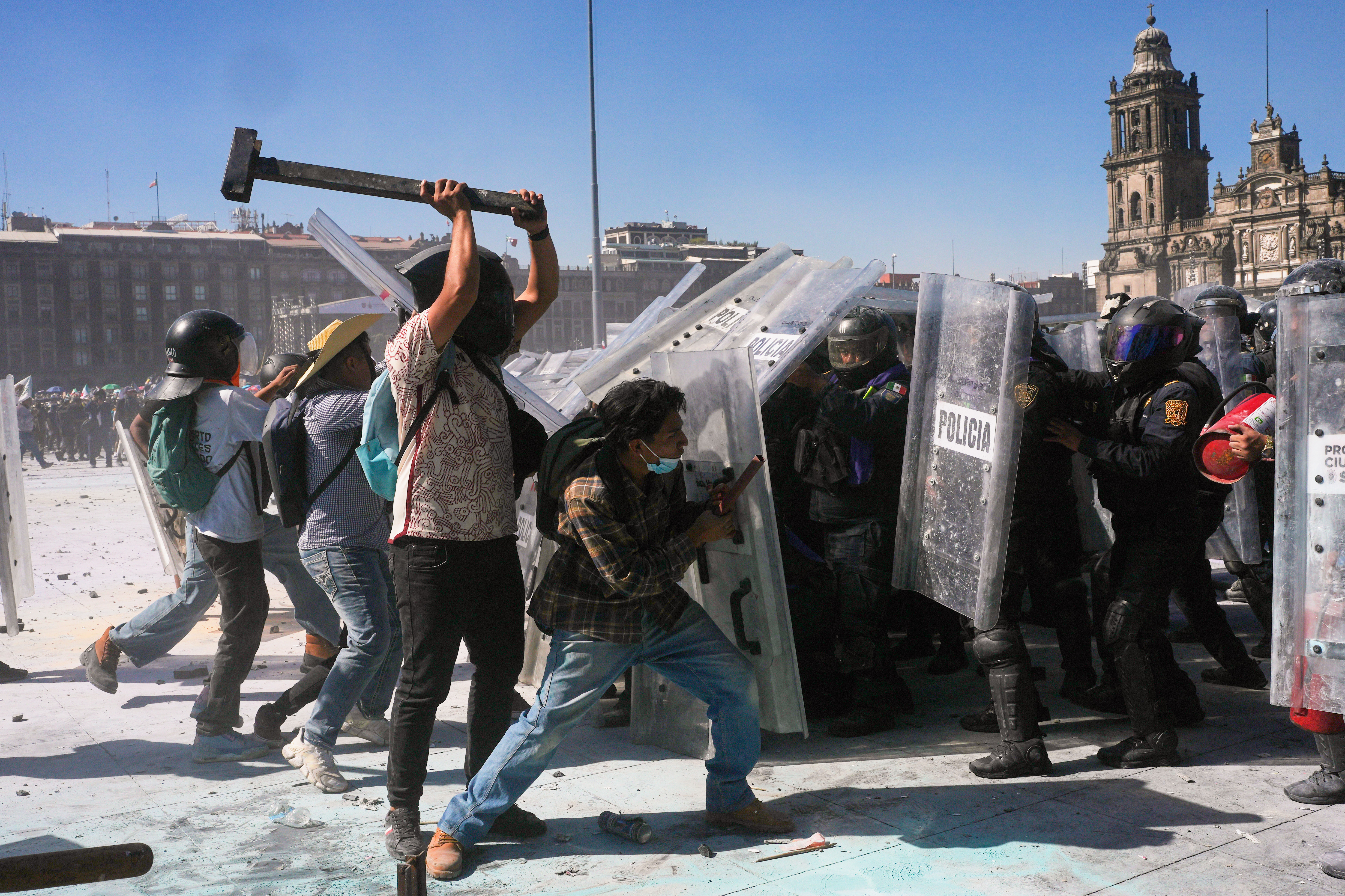 Protesters charge at police during a youth anti-government march in Mexico City