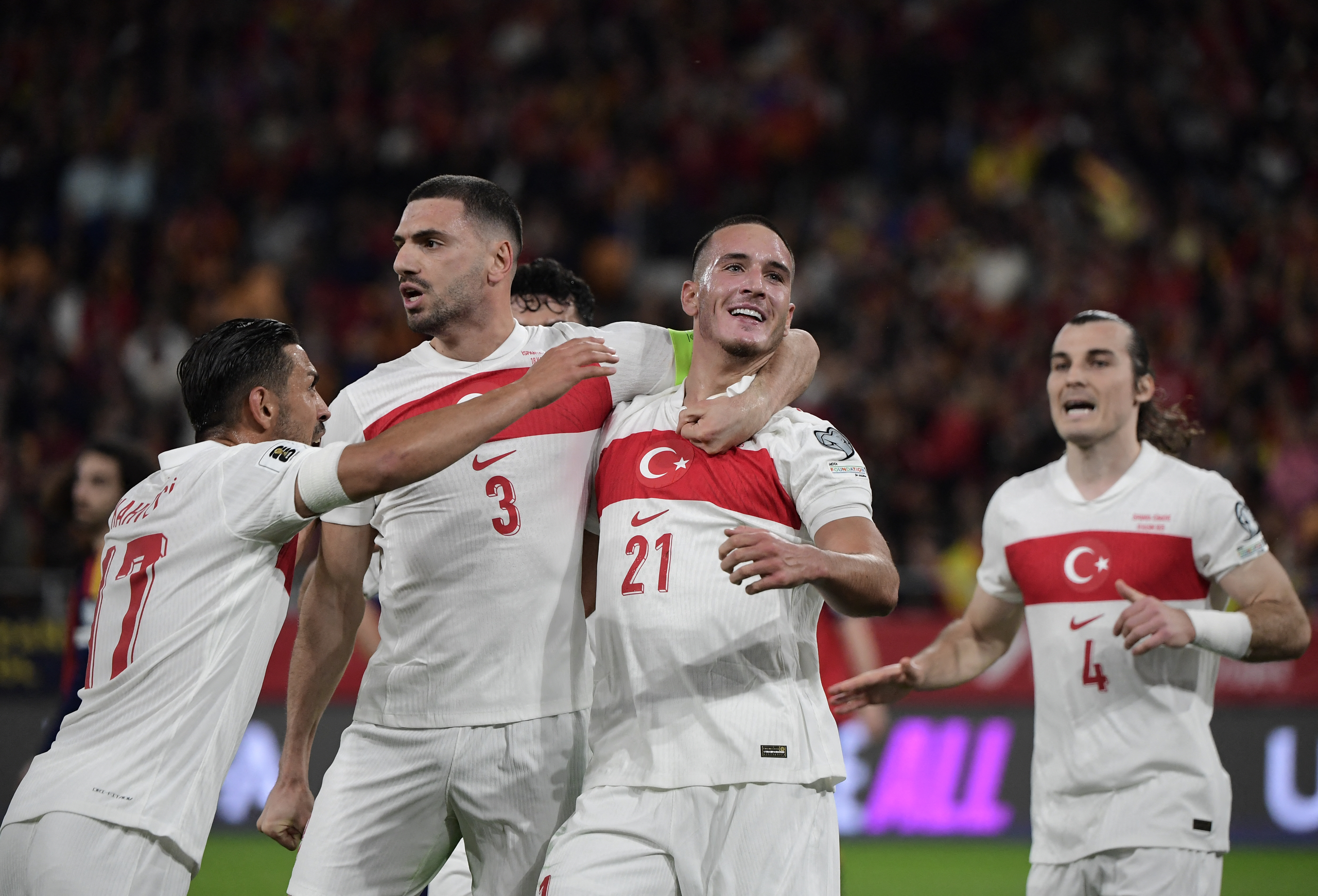 TOPSHOT - Turkey's forward #21 Deniz Gul (R) celebrates with Turkey's defender #03 Merih Demiral scoring his team's first goal during the FIFA World Cup 2026 European qualification Group E football match between Spain and Turkey at the Cartuja stadium in Seville on November 18, 2025.