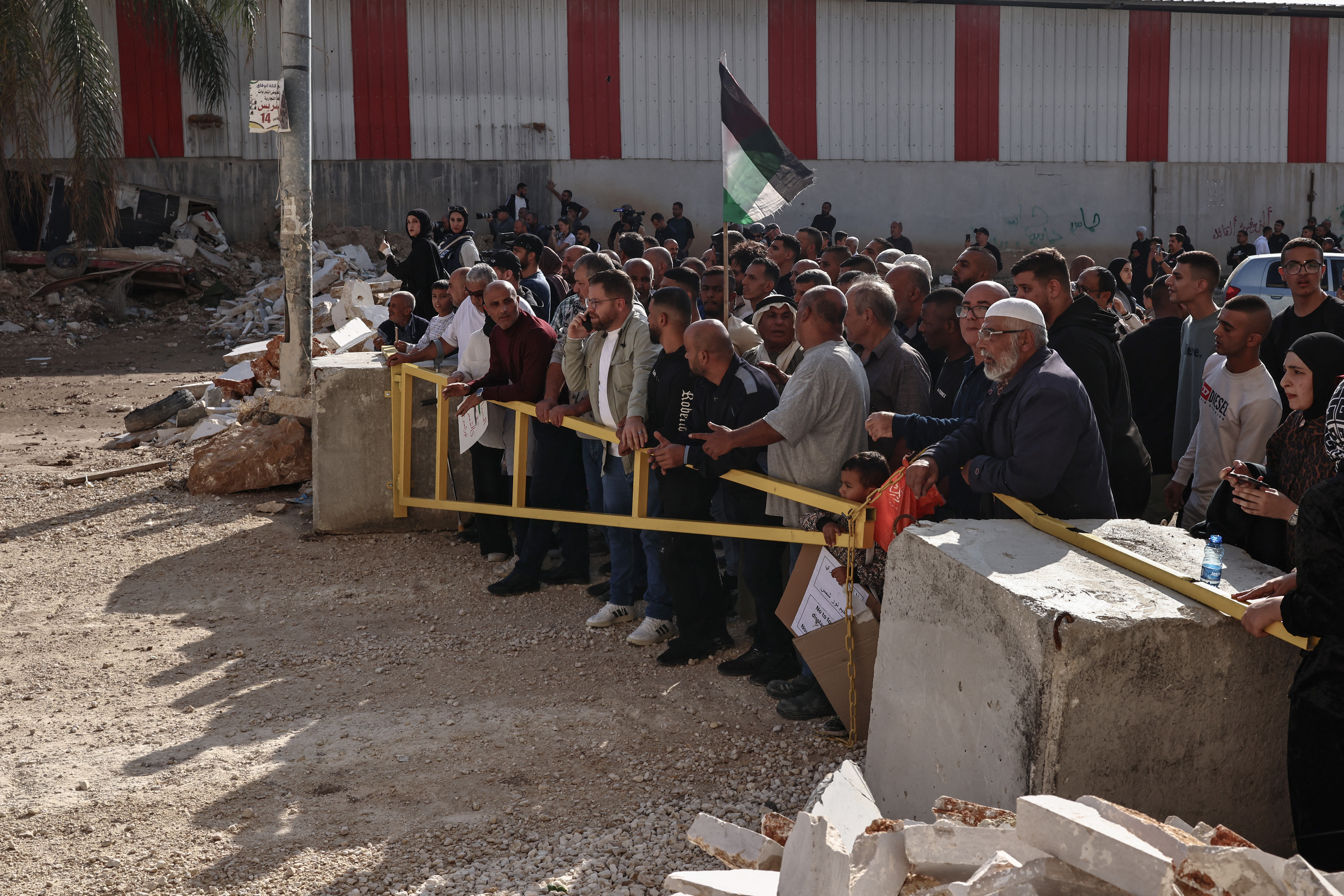 Residents of the Nur Shams refugee camp, near Tulkarem in the Israeli-occupied West Bank, gather at the entrance of the camp during a protest demanding the right to return to their homes, on November 18, 2025.