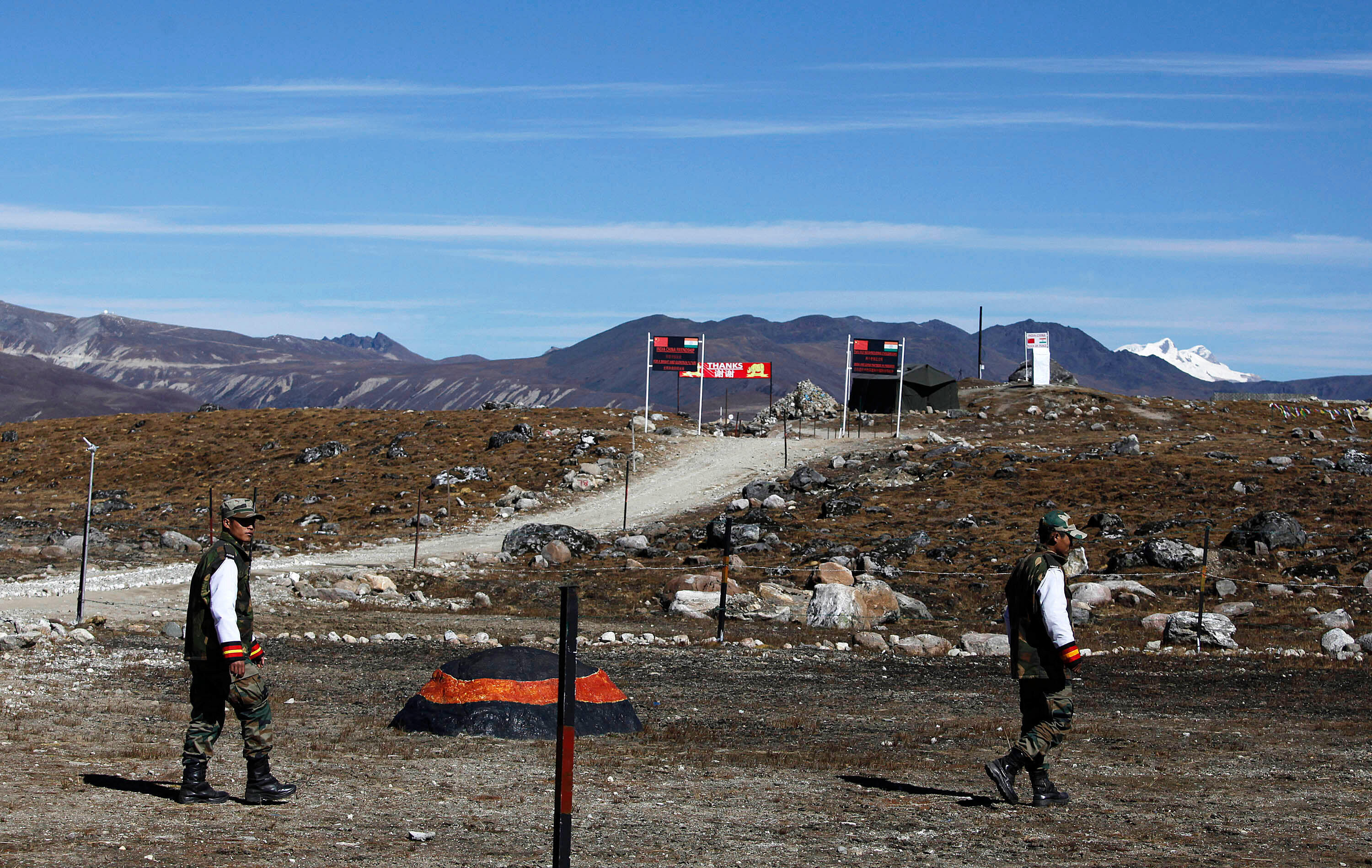 Indian army soldiers walk along the Line of Control at the Indo-China border in Bumla at an altitude of 4,780 metres (15,700 feet) above sea level in Arunachal Pradesh, India, on October 21, 2012