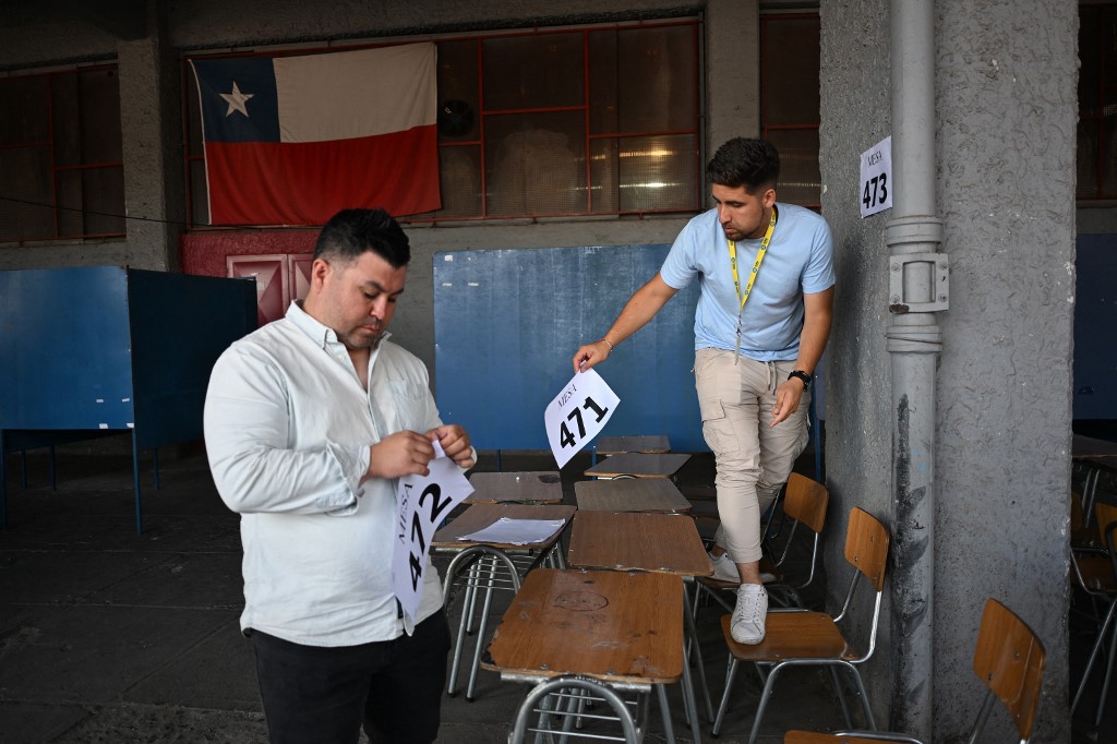 Workers of the Nunoa municipality prepare a polling station at the Estadio Nacional ahead of the second round of the presidential election in Santiago on December 13, 2025.