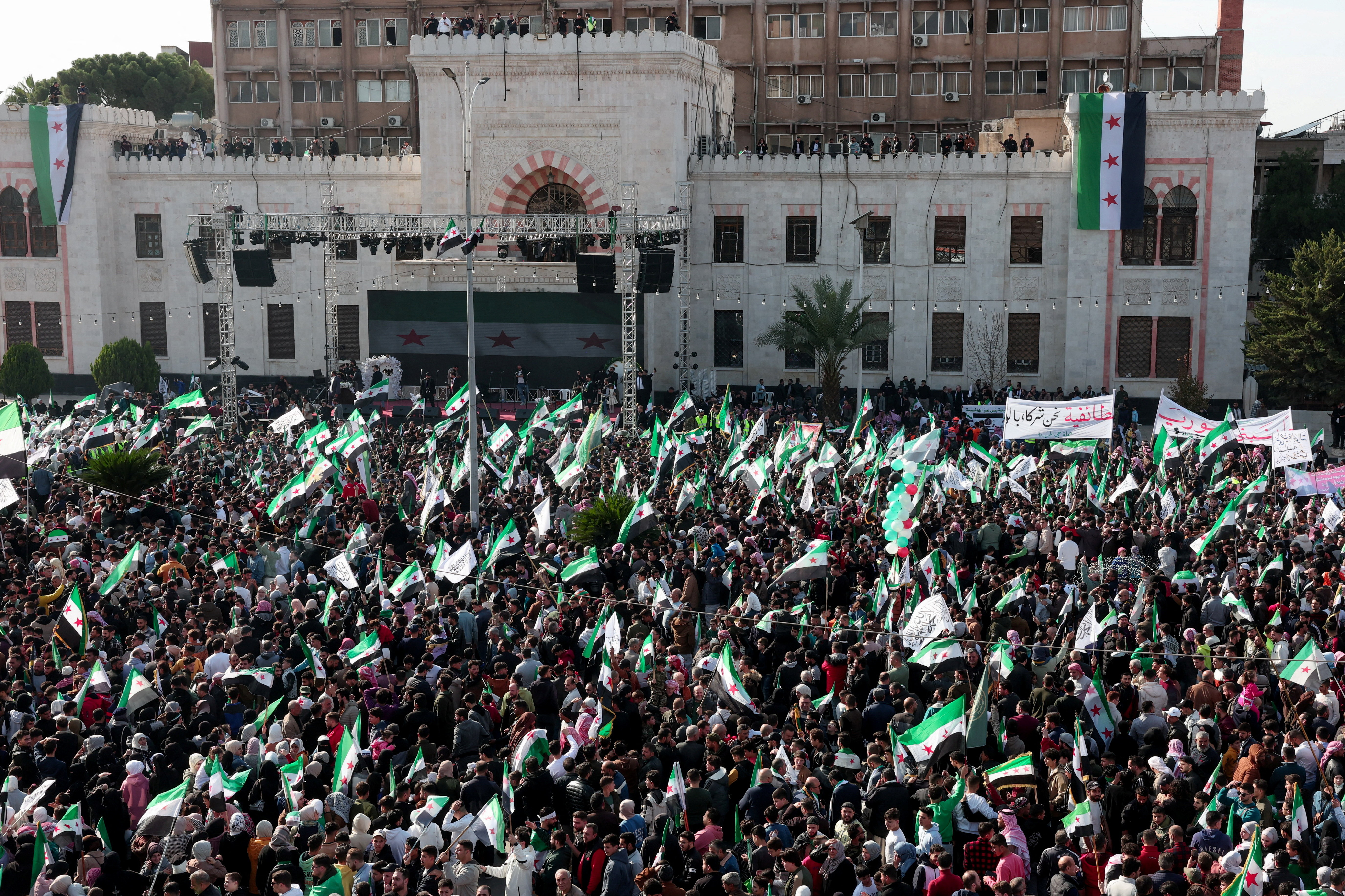 Residents of Hama gather during a protest to mark the first anniversary of the fall of Bashar al-Assad's regime, in Hama, Syria December 5, 2025. REUTERS/Mahmoud Hassano