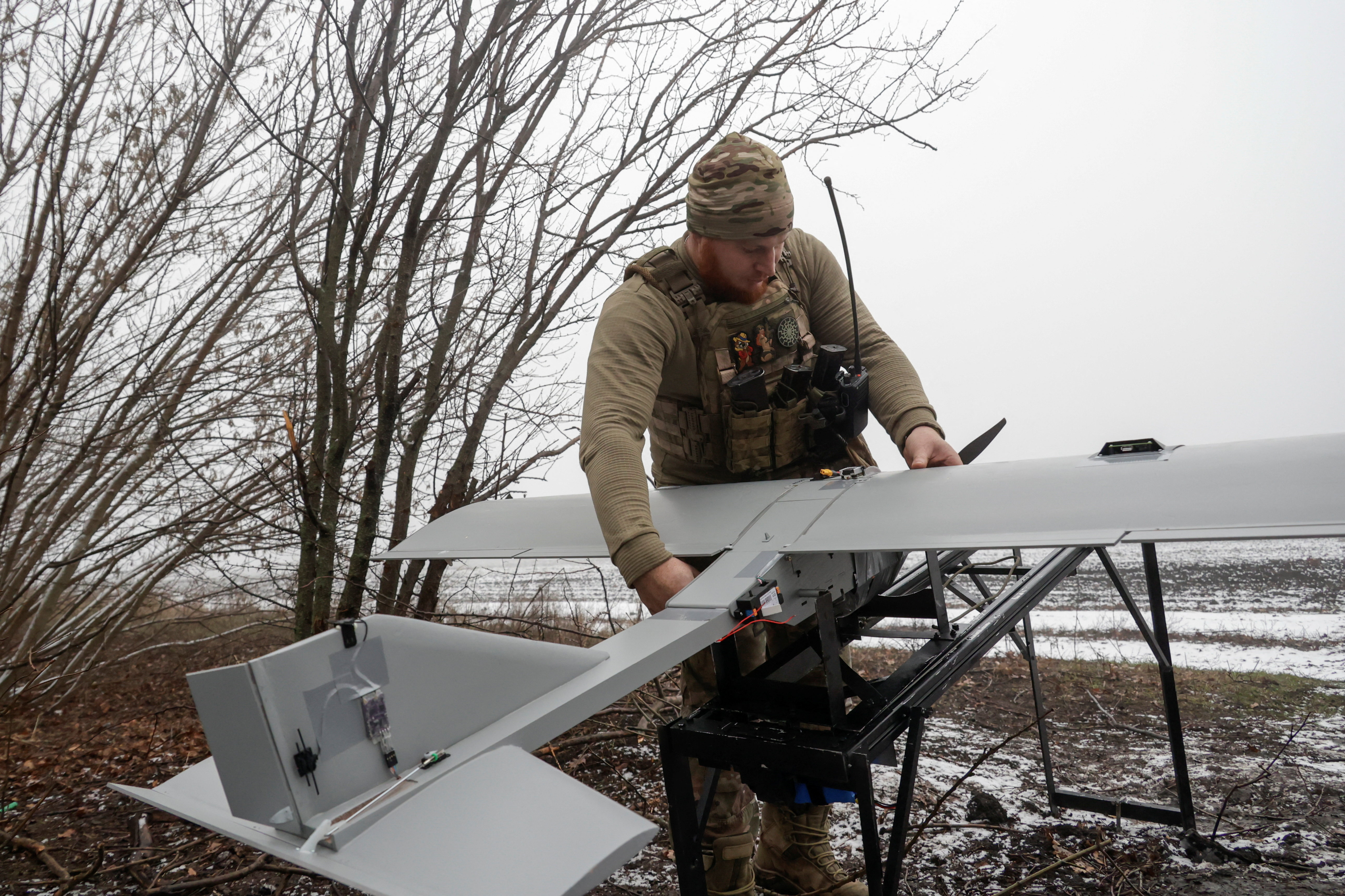 A Ukrainian serviceman prepares to launch a Darts UAV towards Russian troops from a position near a front line in the Donetsk region