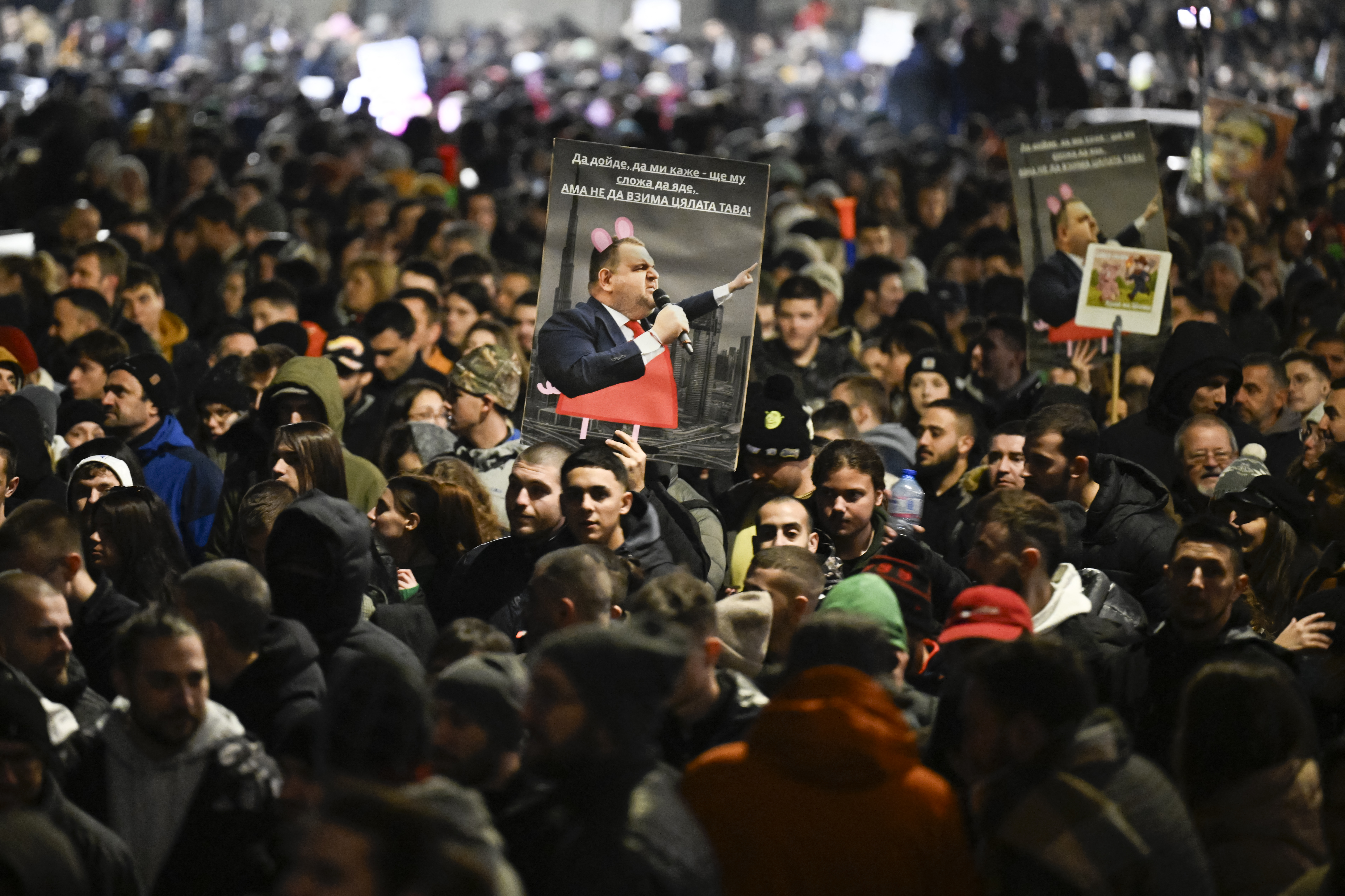 Protesters hold placards depicting Bulgarian politician Delyan Peevski during an anti-government protests in Sofia on December 1, 2025. Tens of thousands of people held anti-government protests in Bulgaria on Monday, widening an anti-corruption movement sweeping the European Union's poorest country as it prepares to adopt the euro. (Photo by Nikolay DOYCHINOV / AFP)