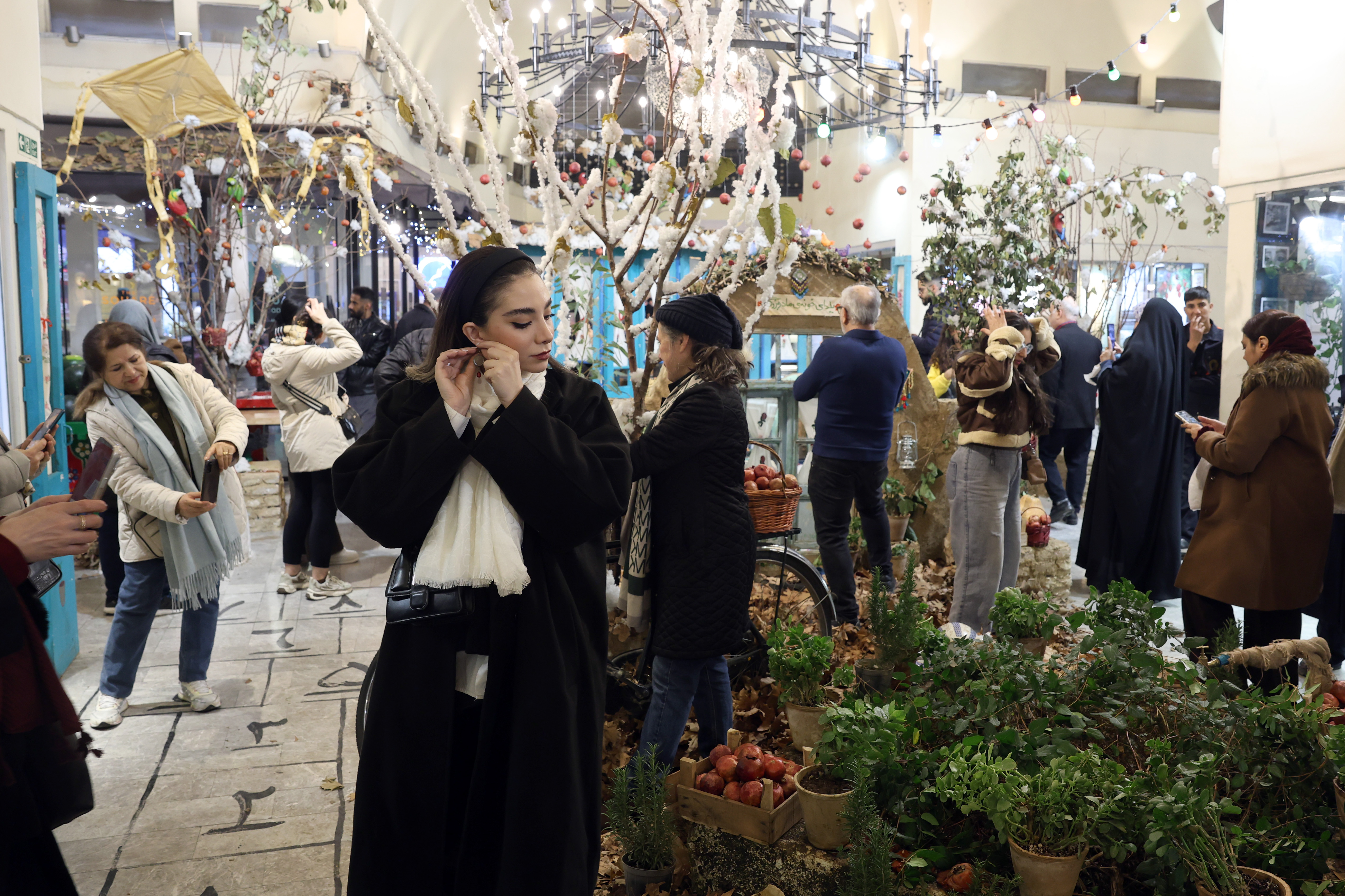 epa12605803 Iranians view Yalda decorations as they prepare to celebrate the Yalda feast in Tehran, Iran, 20 December 2025. Yalda is an ancient tradition marking the onset of winter and the longest night of the year. The celebration goes back thousands of years to the time when Zoroastrianism was the predominant religion of ancient Persia. Watermelons and pomegranates, along with dried fruit, are the main specialties of the Yalda feast. EPA/ABEDIN TAHERKENAREH
