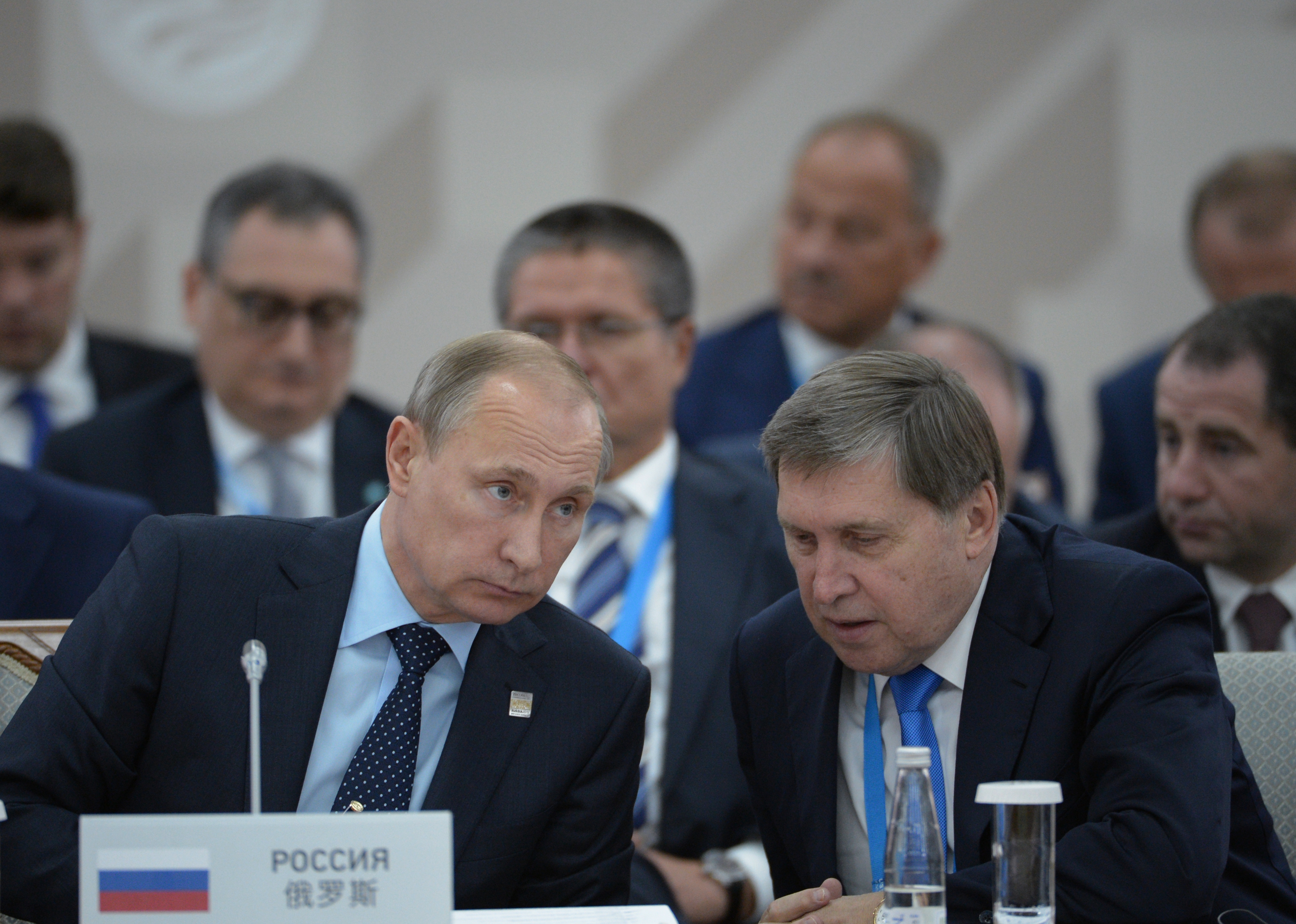 UFA, RUSSIA - JULY 10: In this handout image supplied by Host Photo Agency/RIA Novosti, President of the Russian Federation Vladimir Putin, left, and Presidential Aide Yury Ushakov during the signing of joint documents following the SCO Heads of State Council Meeting. during the BRICS/SCO Summits - Russia 2015 on July 10, 2015 in Ufa, Russia. (Photo by Host Photo Agency/Ria Novosti via Getty Images)