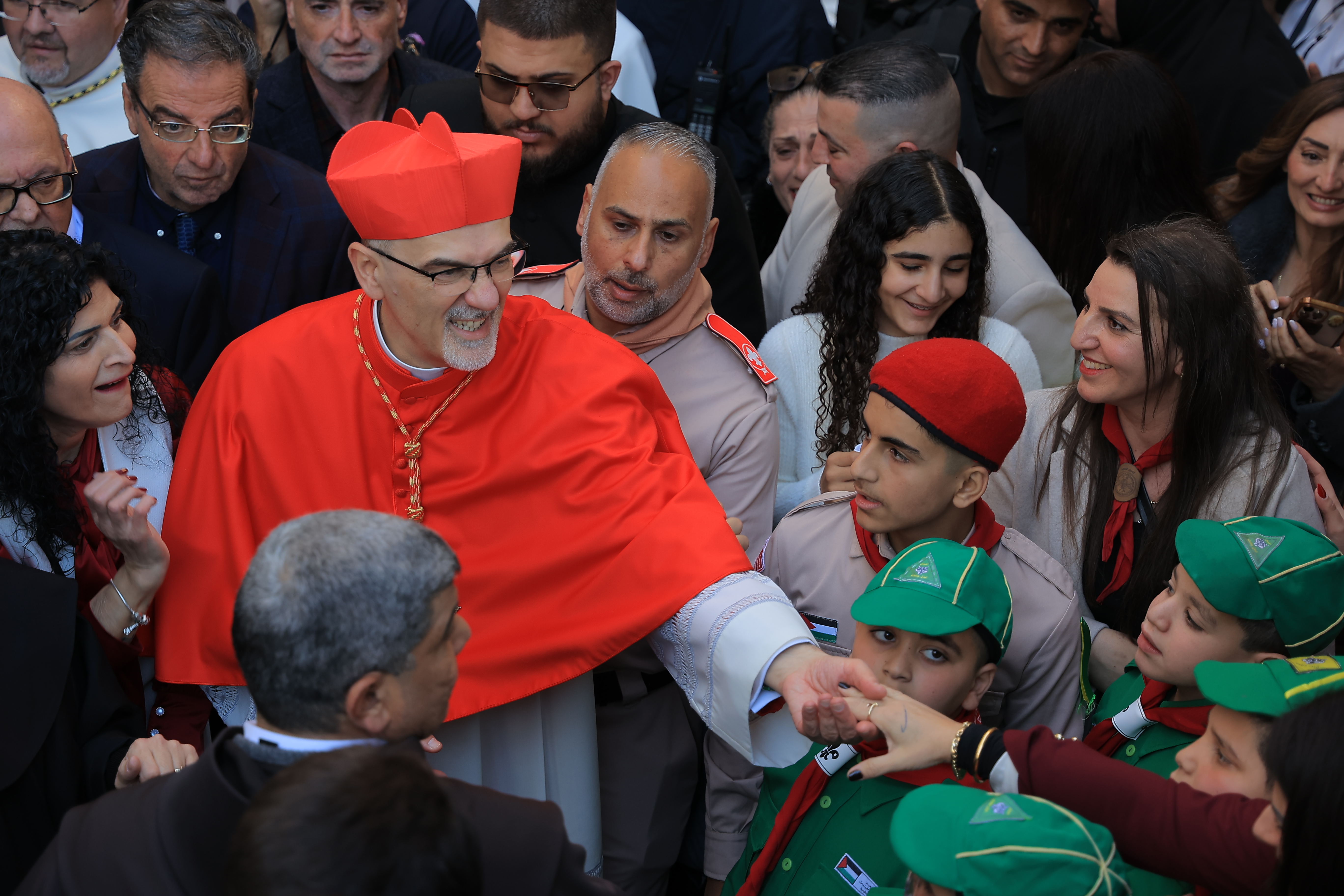 Patriarch Pierbattista Pizzaballa greets Palestinian residents and well-wishers as he arrives at the Church of the Nativity on December 24, on the occasion of Christmas.