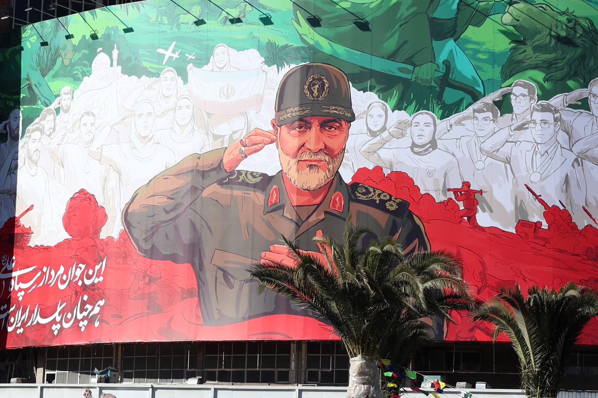 Iranians drive past a huge banner of former Iran Islamic Revolutionary Guard Corps (IRGC) Quds Force commander Qasem Soleimani ahead of the sixth anniversary of his assassination at Valiasr Square in Tehran, Iran, 30 December 2025. [Abedin Taherkenareh/EPA]