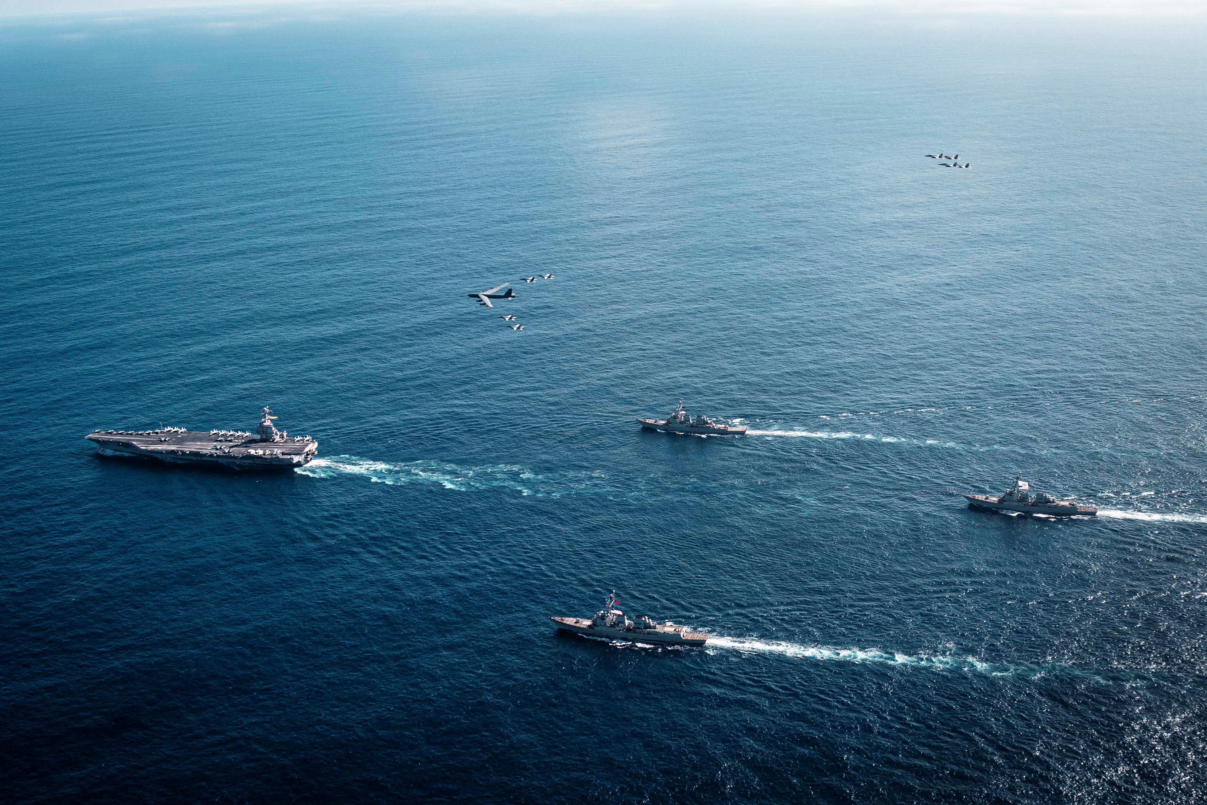 The U.S. Navy’s Gerald R. Ford Carrier Strike Group, including the flagship USS Gerald R. Ford, USS Winston S. Churchill, USS Mahan and USS Bainbridge, sail towards the Caribbean Sea under F/A-18E/F Super Hornets and a U.S. Air Force B-52 Stratofortress, in the Atlantic Ocean November 13, 2025.
