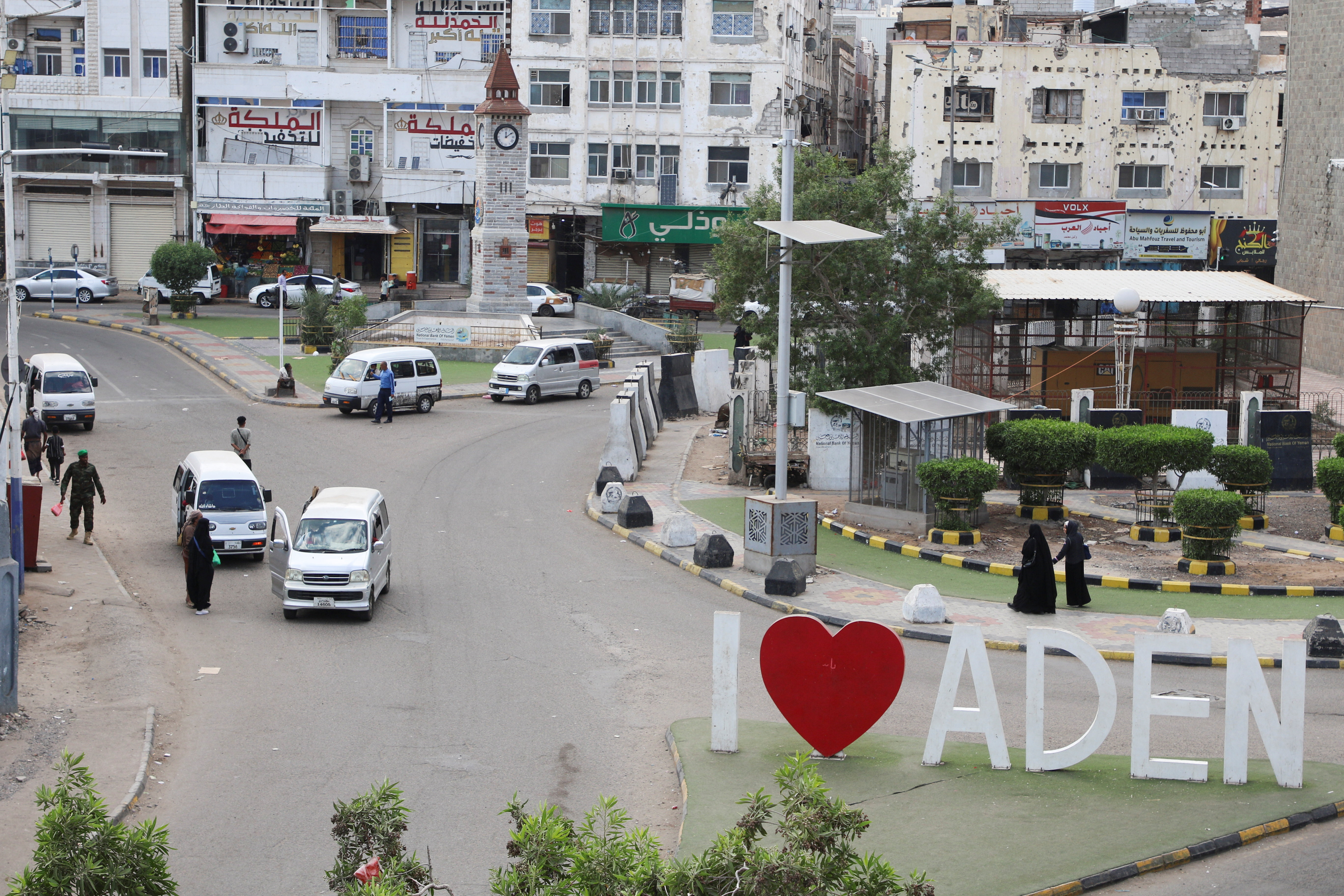 People walk on the street in Aden