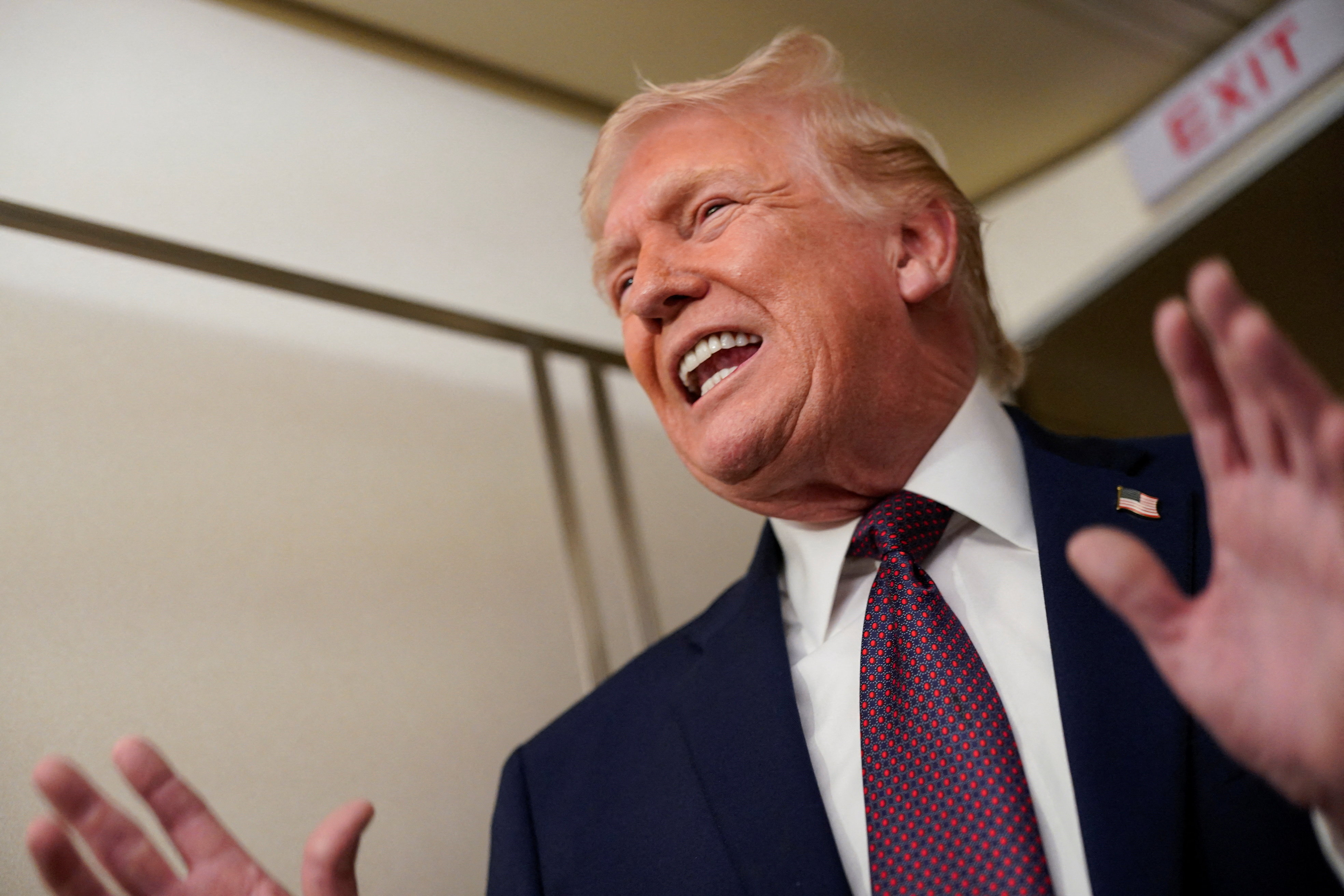 U.S. President Donald Trump speaks with members of the media aboard Air Force One en route from Florida to Washington, U.S., January 11, 2026. REUTERS/Nathan Howard