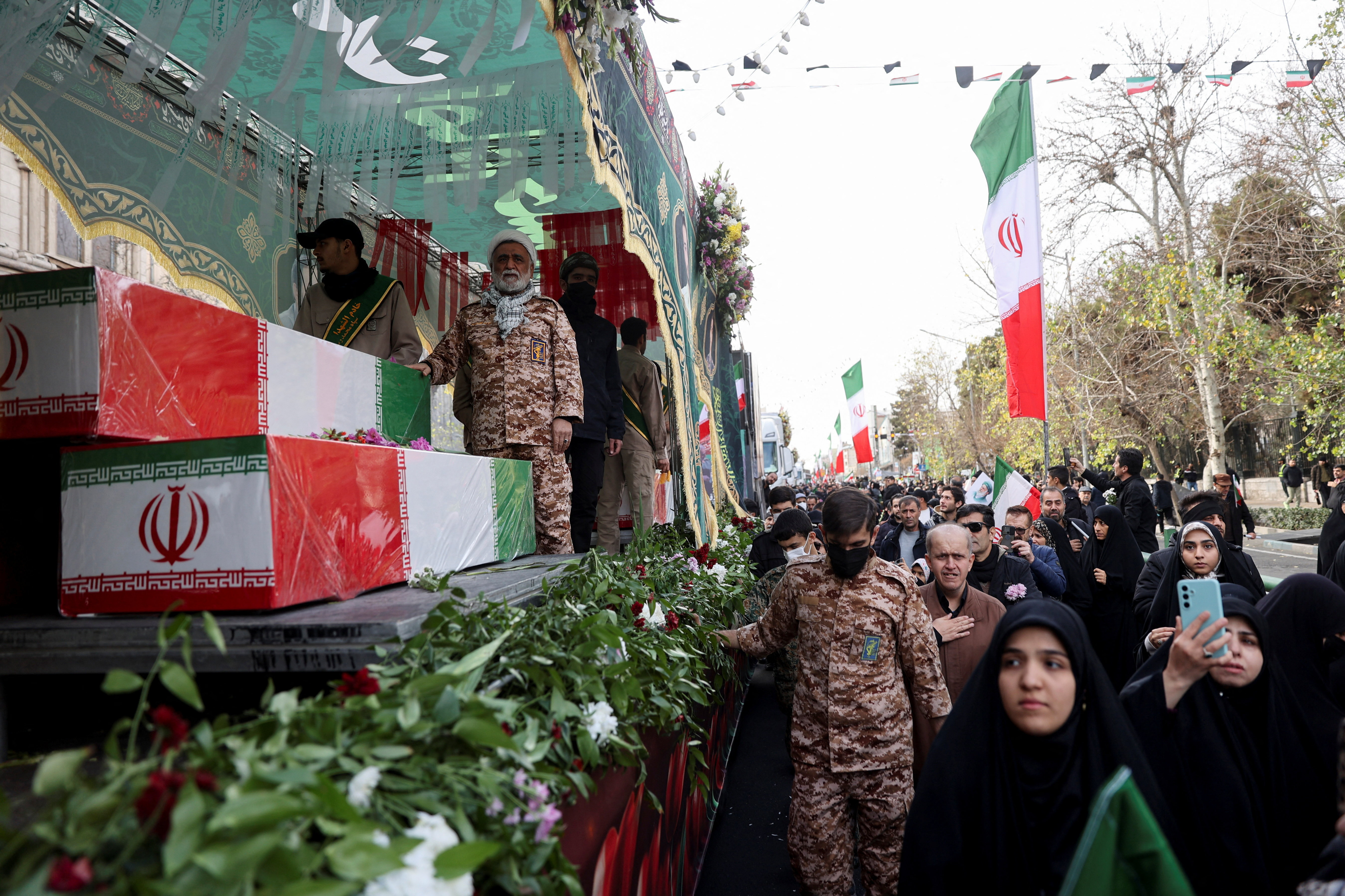 coffins wrapped with Iranian flag