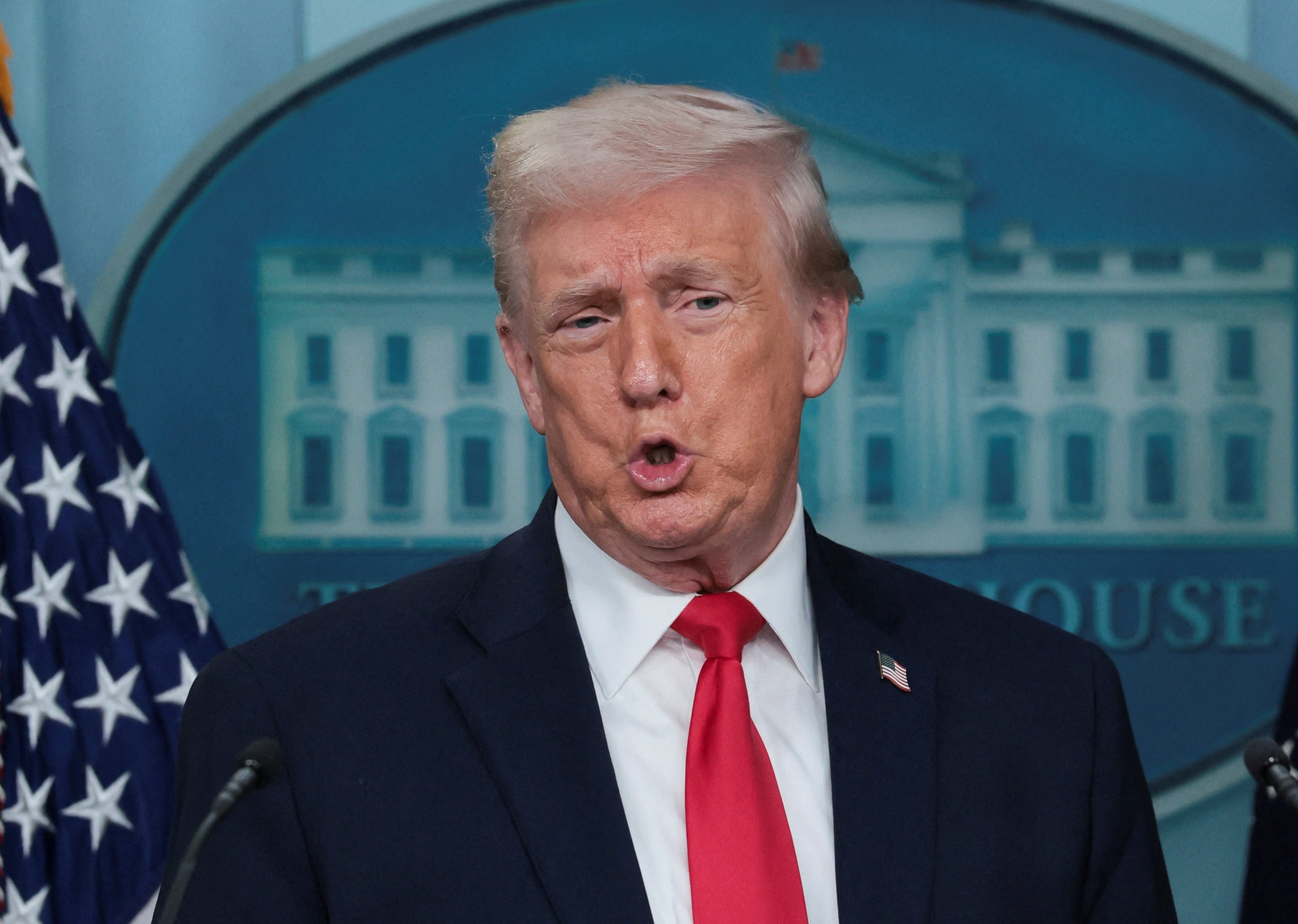 U.S. President Donald Trump makes an impression of Minnesota congresswomen as he speaks during a press briefing at the White House, on the one-year mark into his second term in office, in Washington, D.C., U.S., January 20, 2026. [Jessica Koscielniak/Reuters]