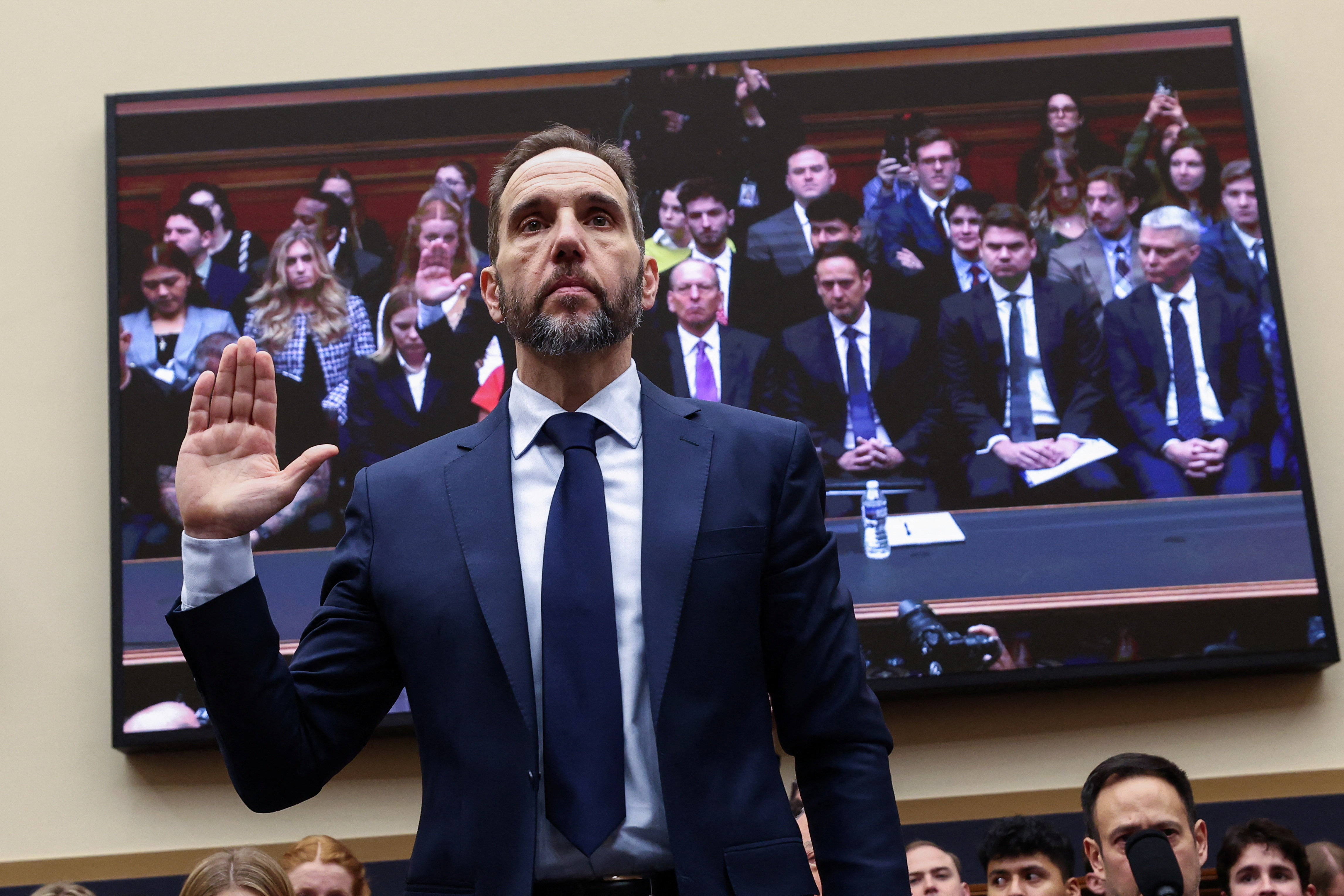 Jack Smith raises his hand to be sworn in