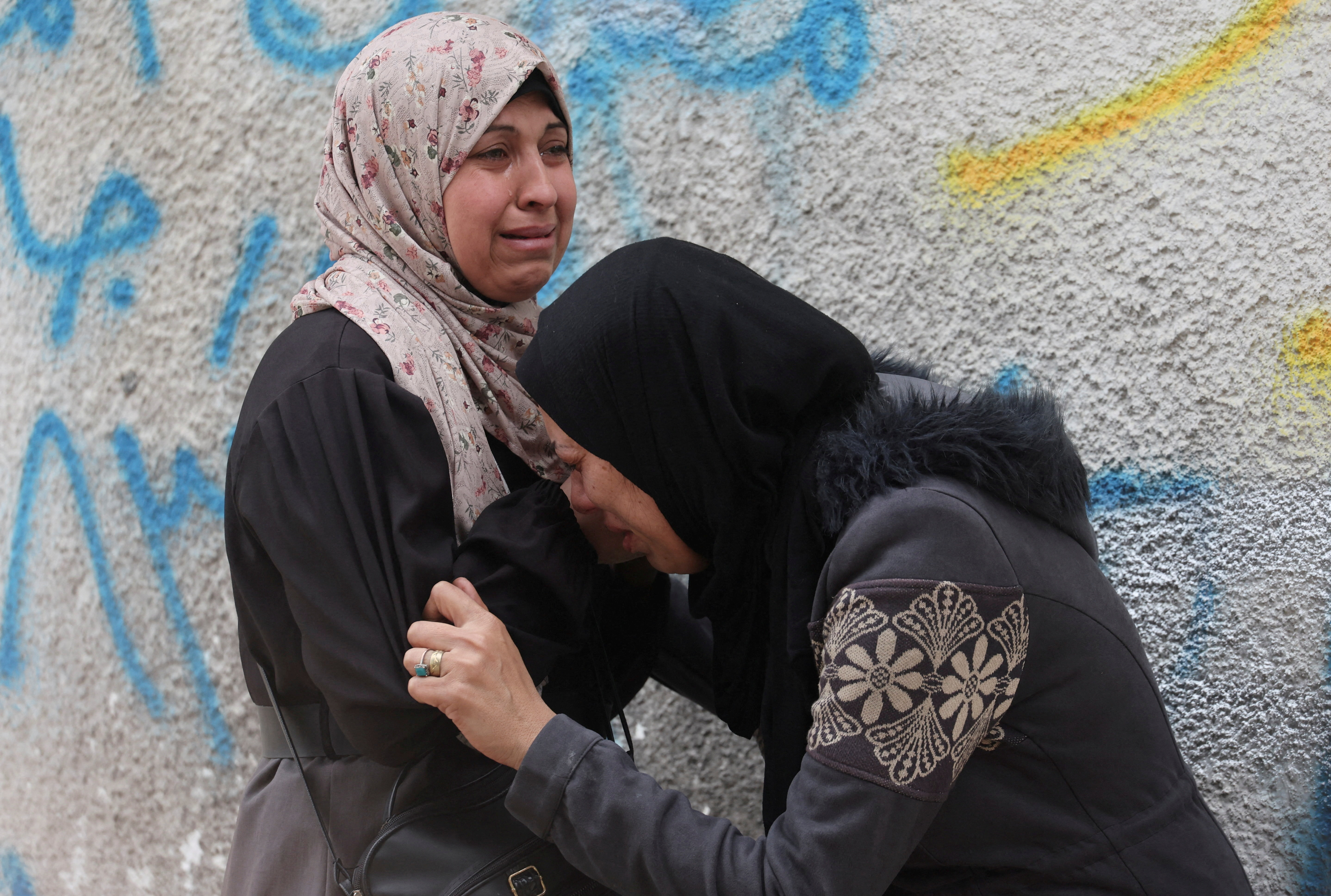 Mourners react during the funeral of Palestinians killed in Israeli strikes, at Al-Shifa Hospital in Gaza City