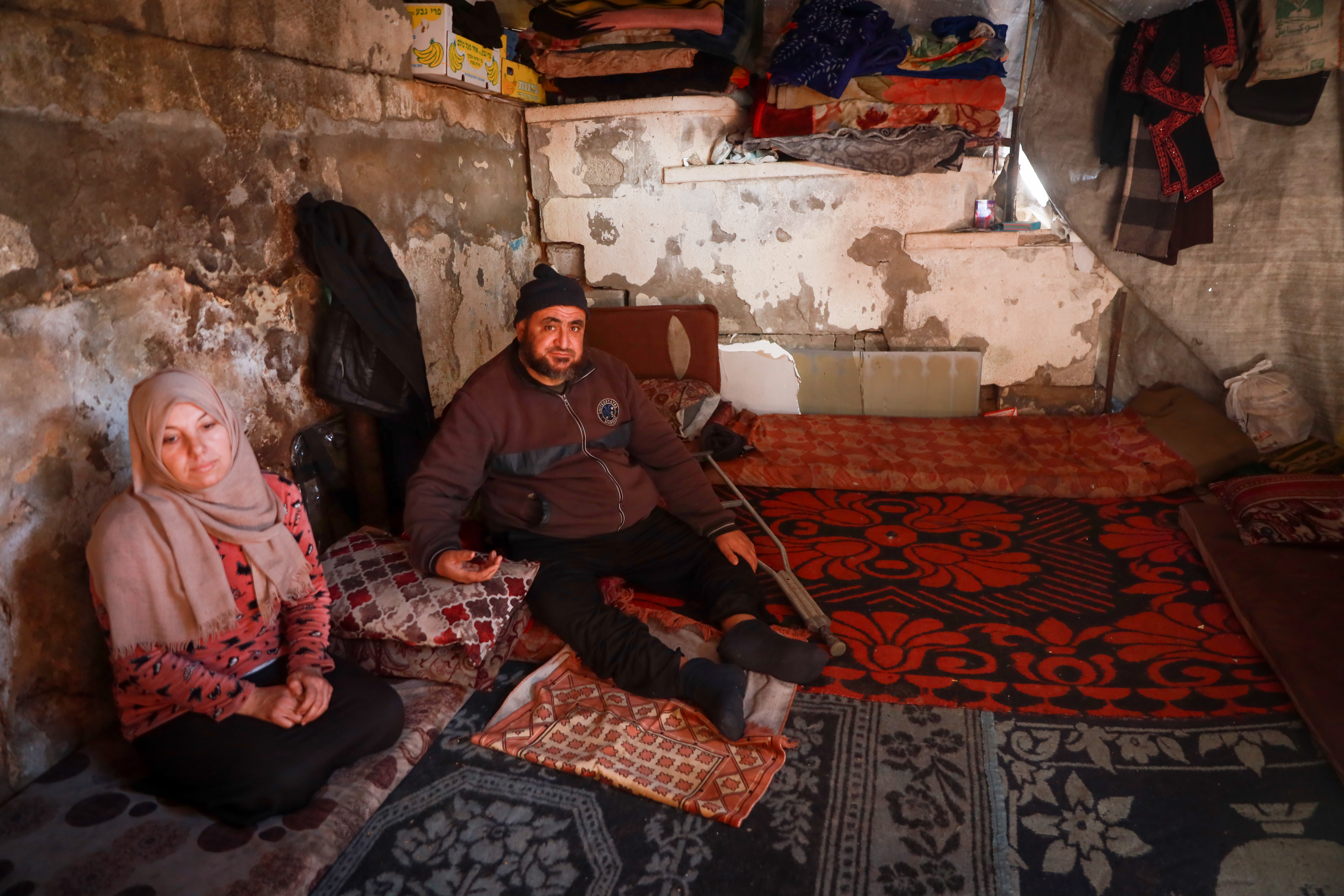 Couple sit in shelter next to stairs 