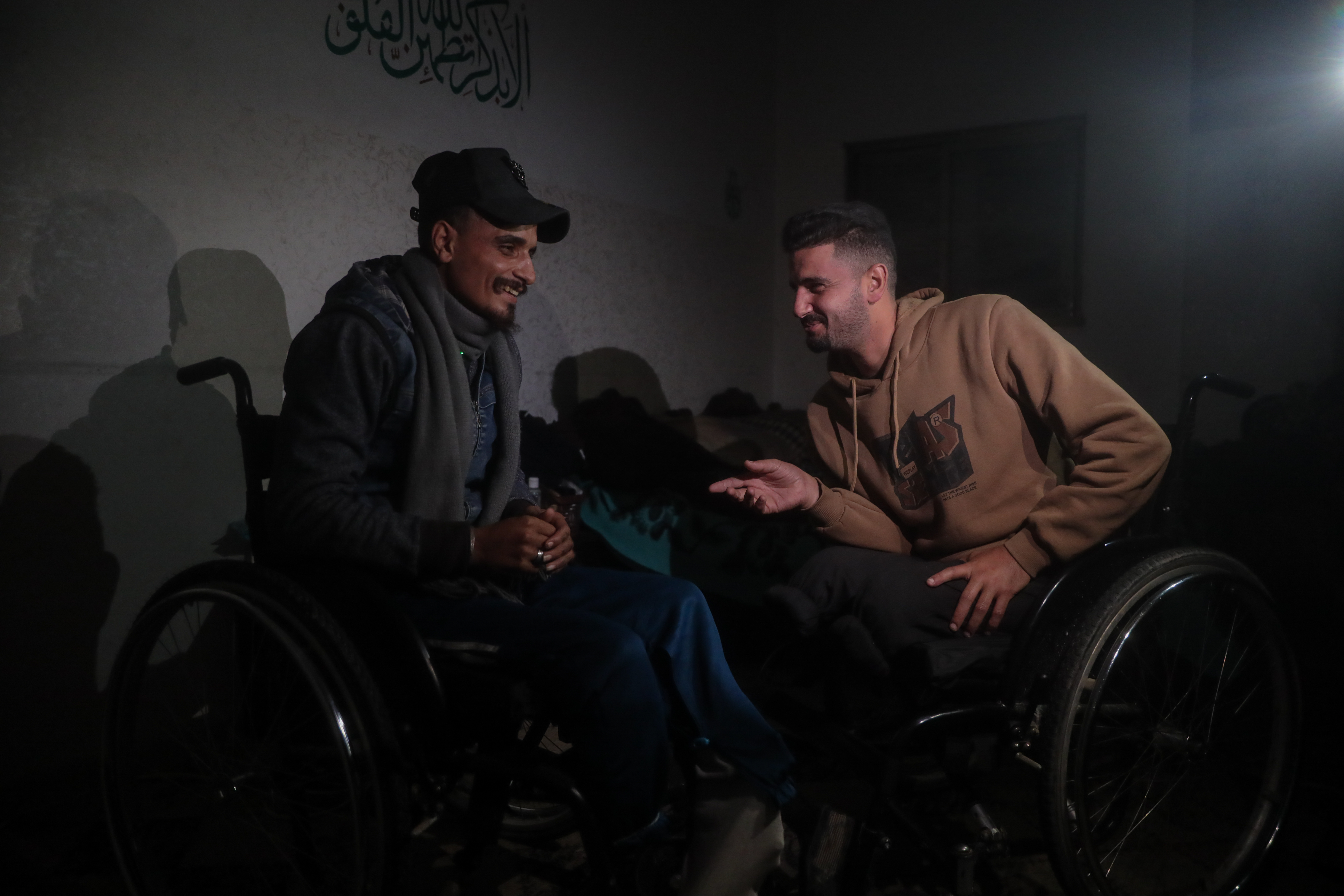 Abdullah Nattat and his cousin Diaa Abu Nahl find solace in their shared suffering and hope to be able to travel abroad for treatment and prosthetic limbs [Abdelhakim Abu Riash/ Al Jazeera]