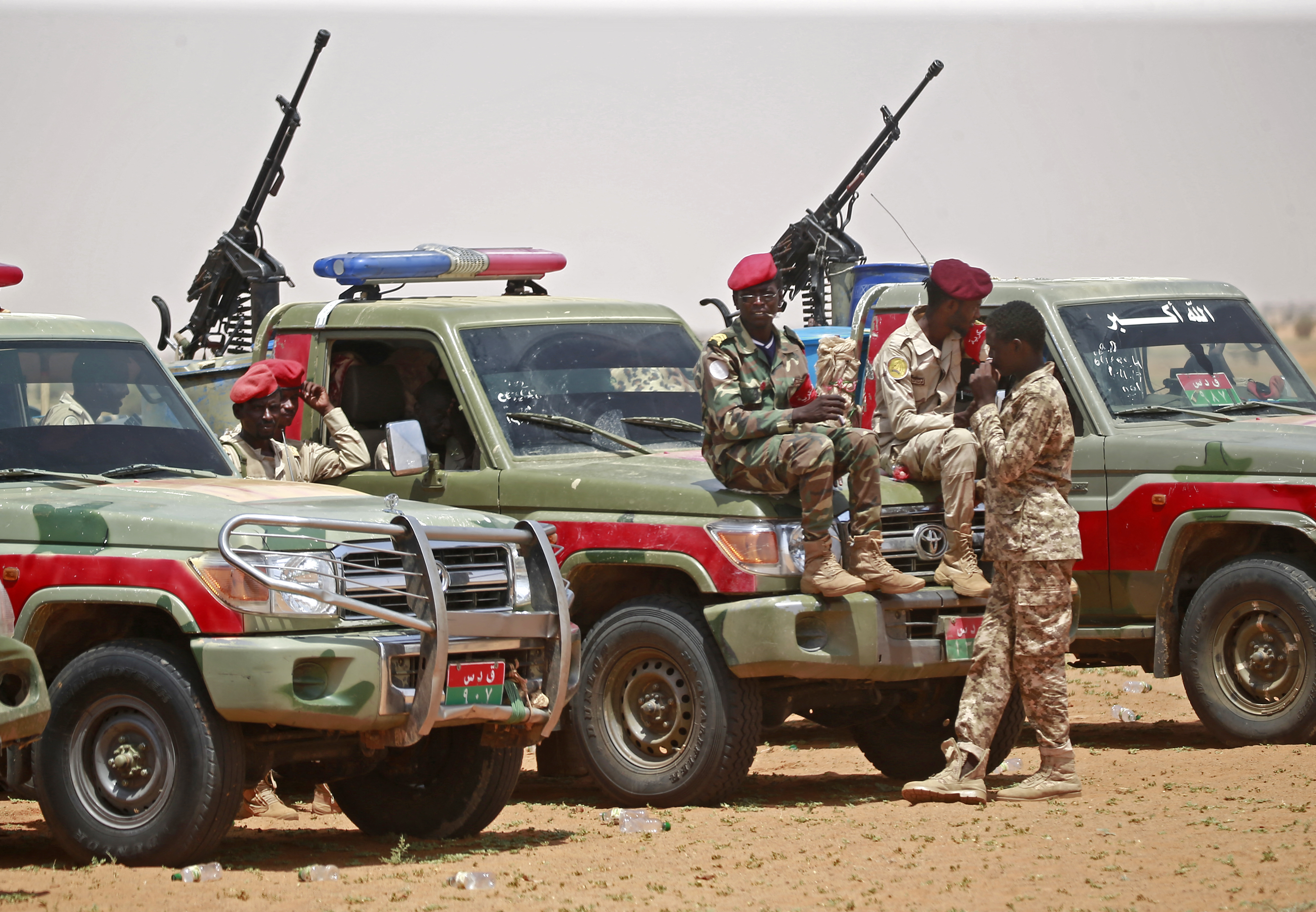 Sudanese paramilitary Rapid Support Forces (RSF) stand in front of military vehicles.
