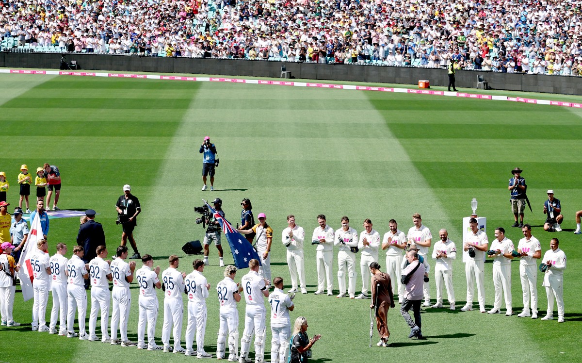 Emergency service personnel and members of the public who responded during a mass shooting at Bondi Beach including Ahmed al Ahmed (R), the man who tackled and disarmed one of the attackers, receive a guard of honour on day one of the fifth Ashes cricket Test match between Australia and England at the Sydney Cricket Ground (SCG) in Sydney on January 4, 2026. England and Australia's cricket teams honoured at the fifth Ashes Test in Sydney on January 4 emergency service personnel and members of the public who responded during a mass shooting at Bondi Beach. (Photo by Glenn NICHOLLS / AFP) / --IMAGE RESTRICTED TO EDITORIAL USE - STRICTLY NO COMMERCIAL USE--