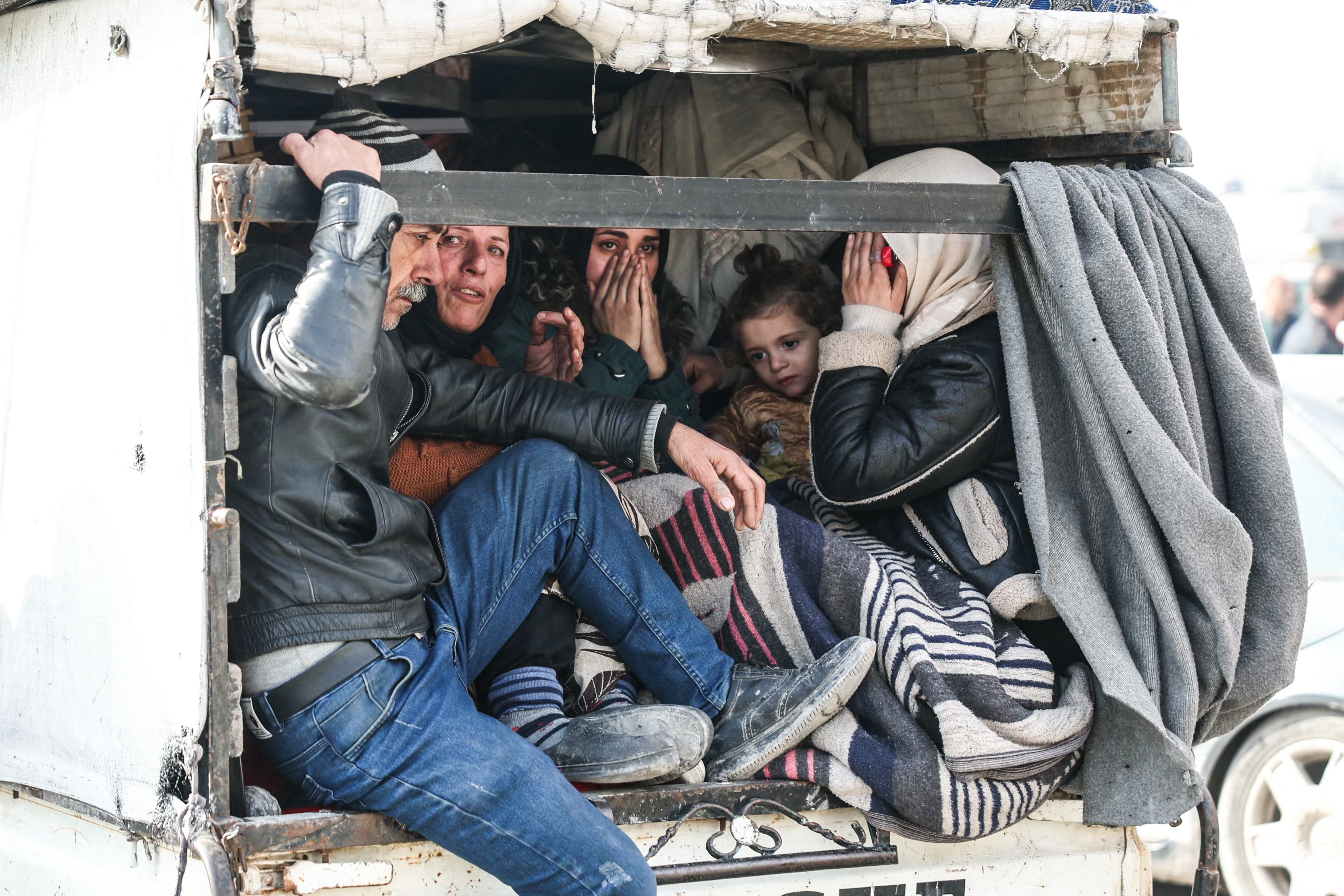 Residents flee from the predominantly Kurdish neighborhoods of Sheikh Maqsud and Ashrafiyeh in the city of Aleppo on January 8, 2026, amid intense clashes between government forces and the Kurdish Syrian Democratic Forces (SDF) forces. Syria's government on January 7, 2026, demanded that Kurdish fighters leave the neighbourhoods they control in Aleppo following clashes between the two sides which saw thousands of civilians flee. The Syrian government and Kurdish-led forces traded blame over who started the deadly clashes on January 6, which killed 16 civilians and one defence ministry member. (Photo by OMAR HAJ KADOUR / AFP)