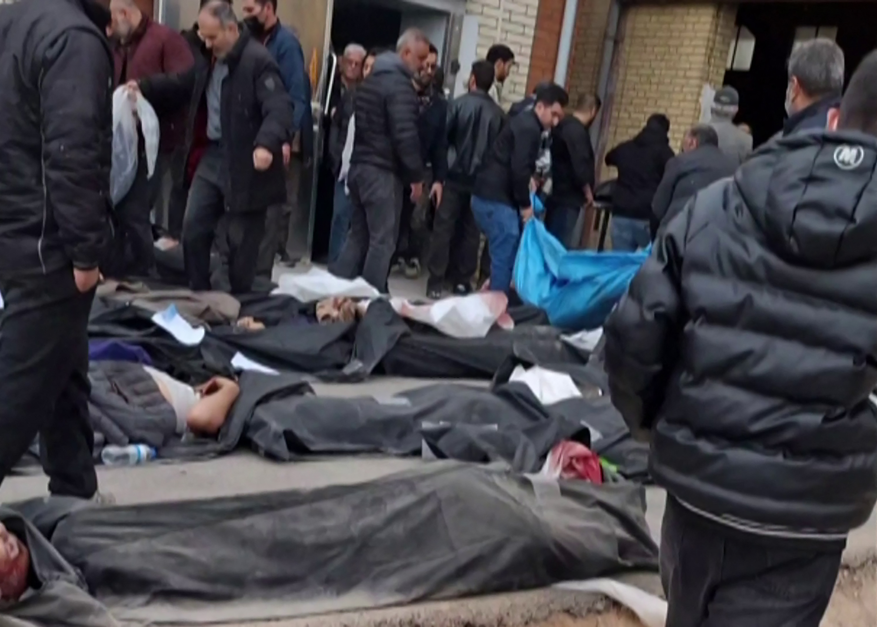 EDITORS NOTE: Graphic content / This video grab taken on January 14, 2026 from UGC images posted on social media on January 13, 2026, shows bodies lying on the ground at the Tehran Province Forensic Diagnostic and Laboratory Centre in Kahrizak, as grieving relatives search for their loved ones. Other videos showing the same scenes first appeared online on January 10, 2026.