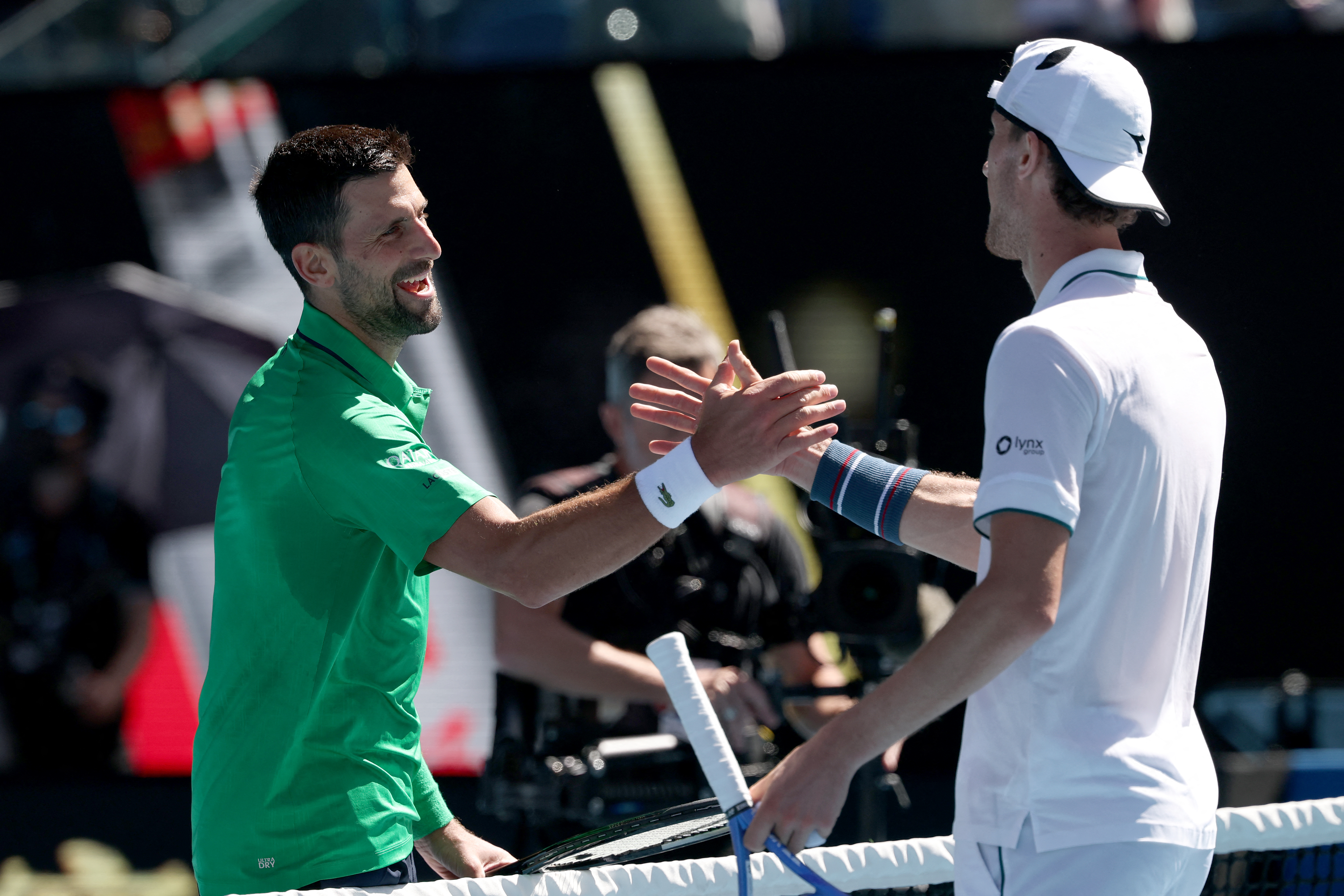 Novak Djokovic and Francesco Maestrelli react.