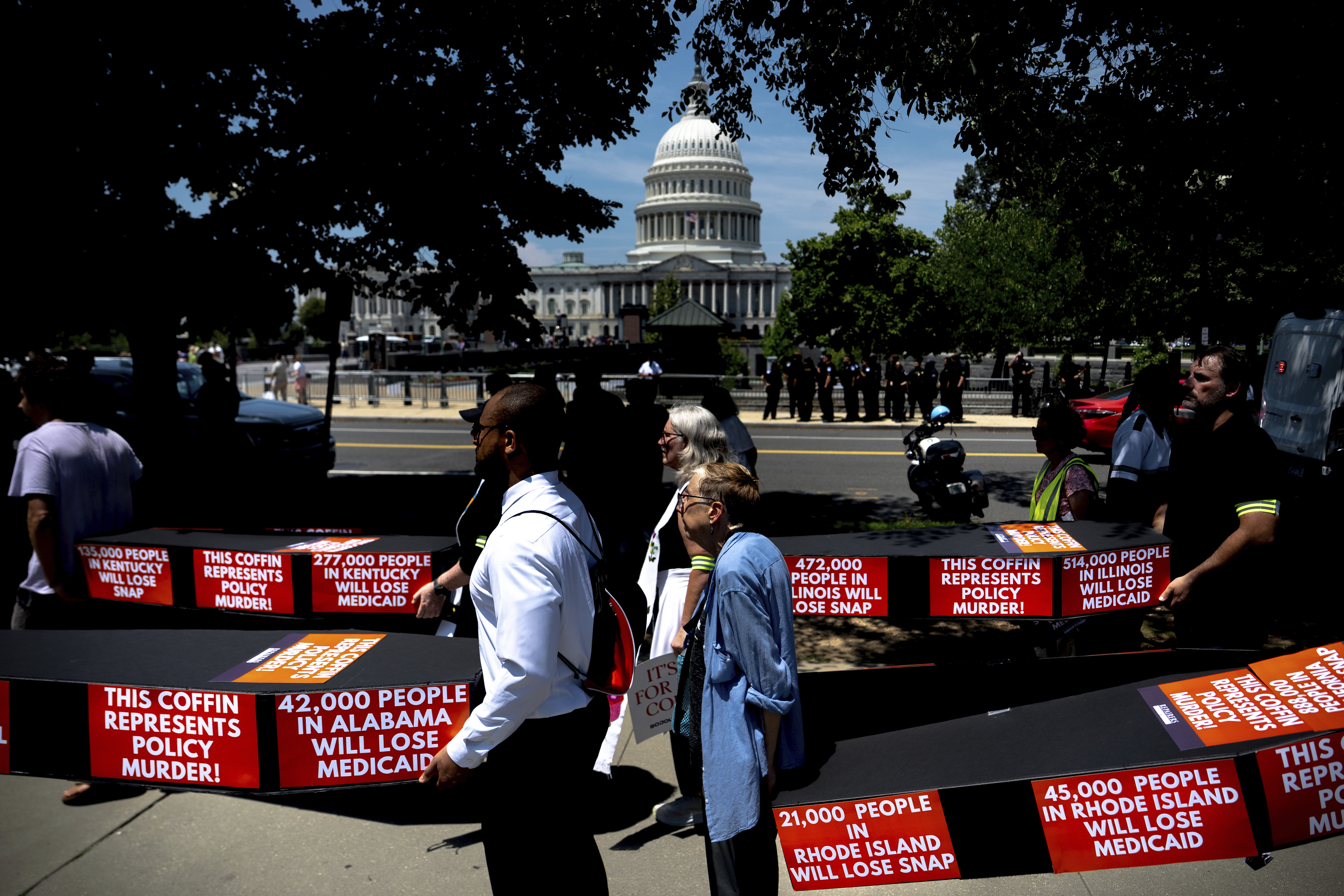Protesters carry caskets symbolizing the potential for death upon losing access to Medicaid