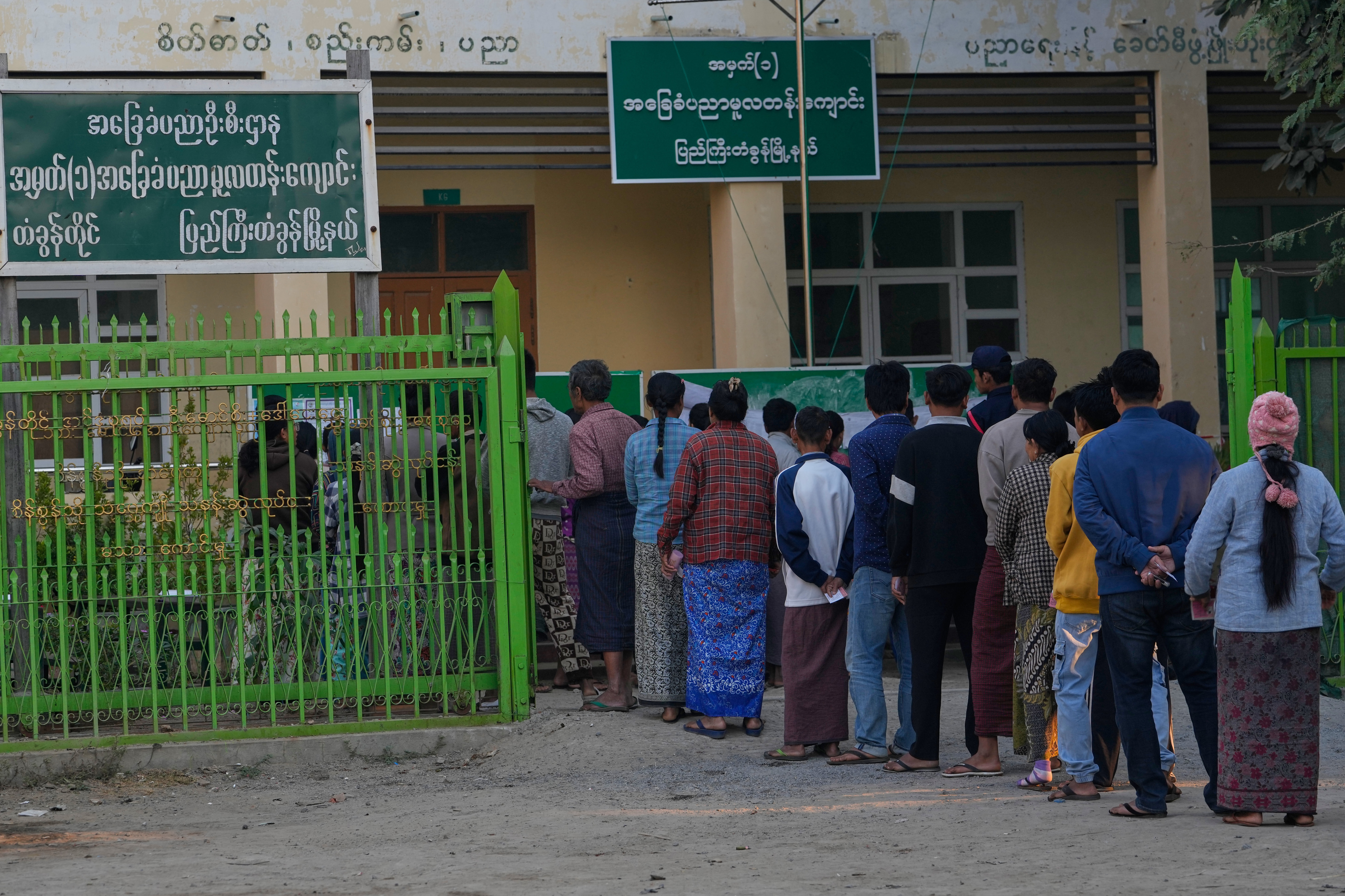 Voters line up to cast their ballots at a polling station during the second phase of general election in Mandalay, central Myanmar, Sunday, Jan. 11, 2026. (AP Photo/Aung Shine Oo)
