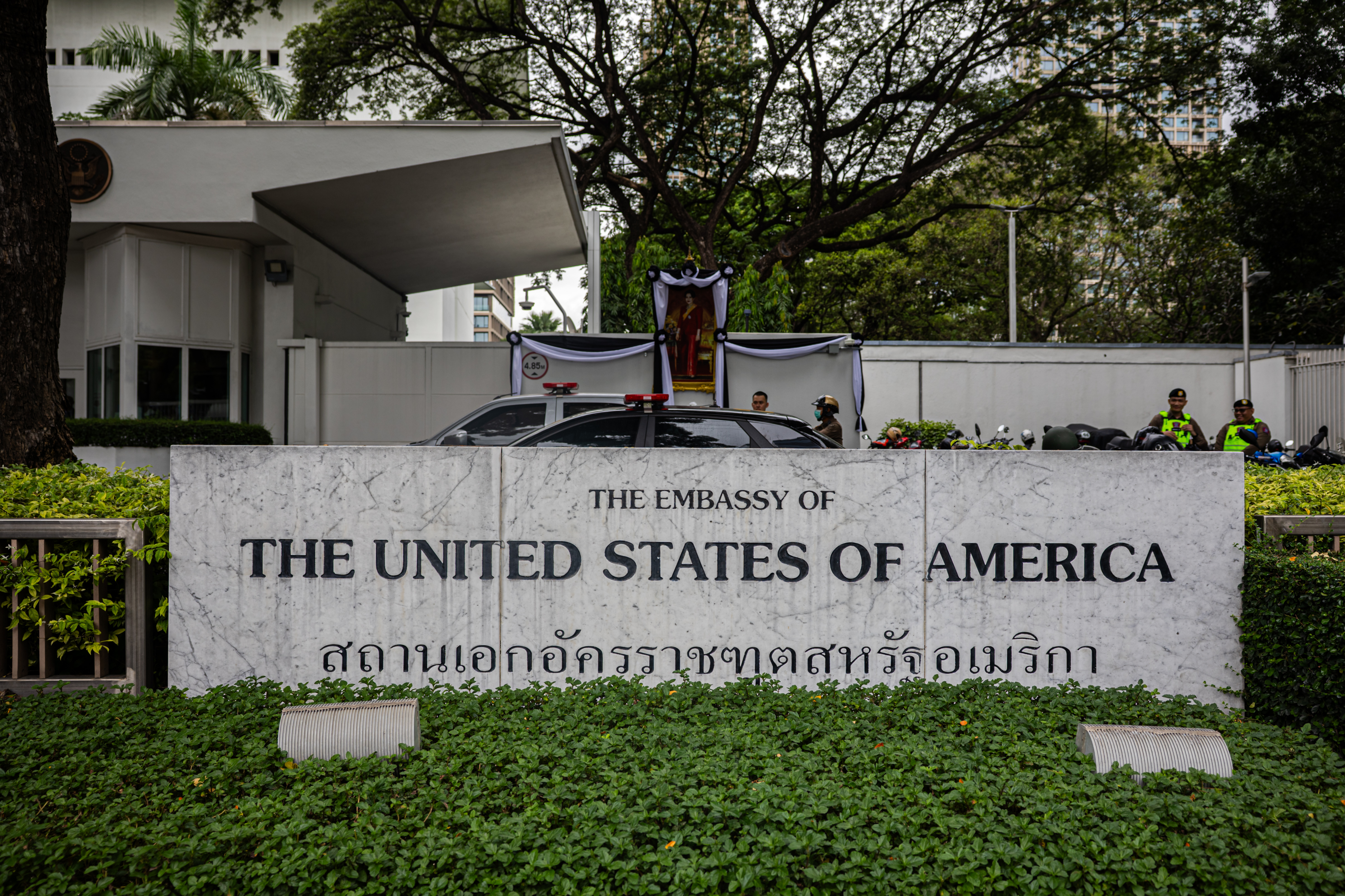 Police officers stand on patrol as environmental protesters gather in front of the US embassy in Bangkok.