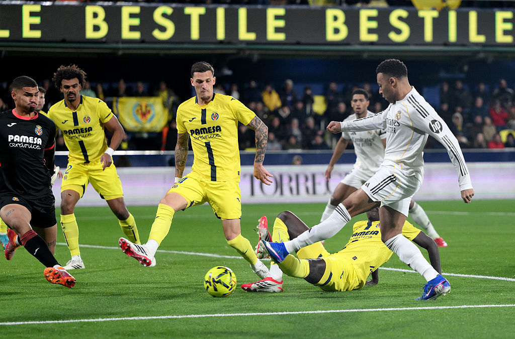 Kylian Mbappe of Real Madrid scores his team's first goal past Luiz Junior of Villarreal
